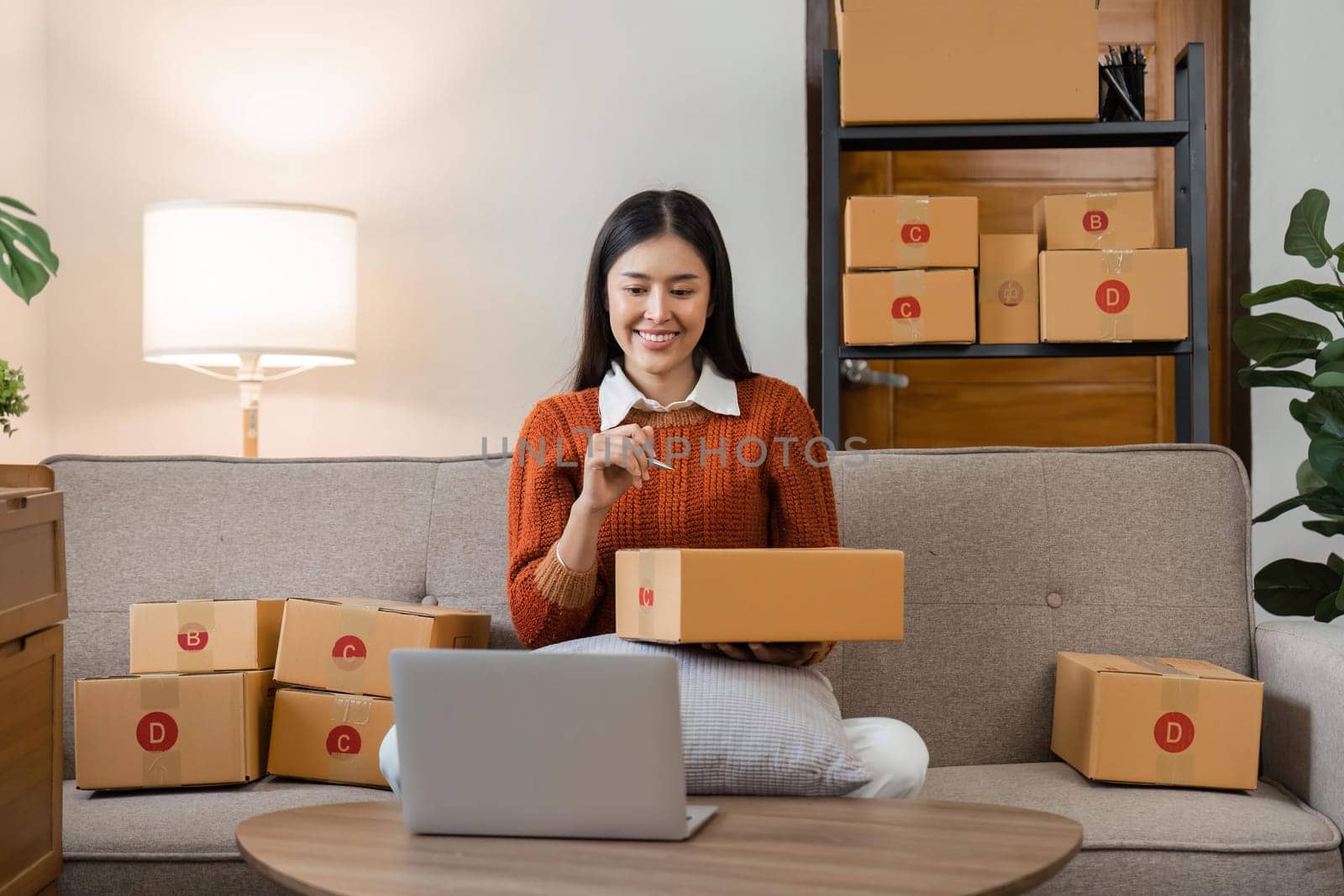 woman sell products online Small Business , Young Asian women happy after a new order from the customer, business owner working at home by nateemee