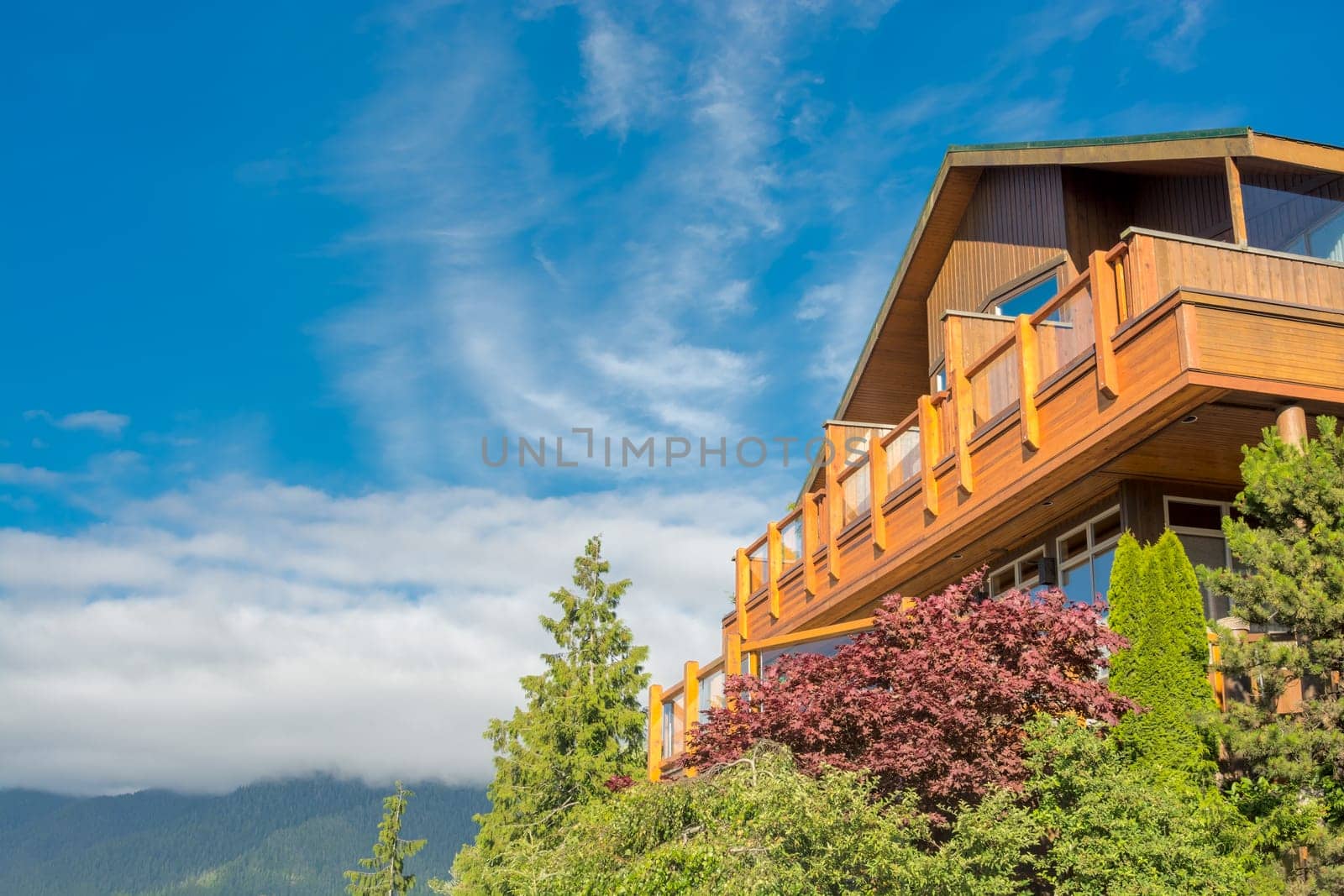 Top of wooden residential house on blue sky background.