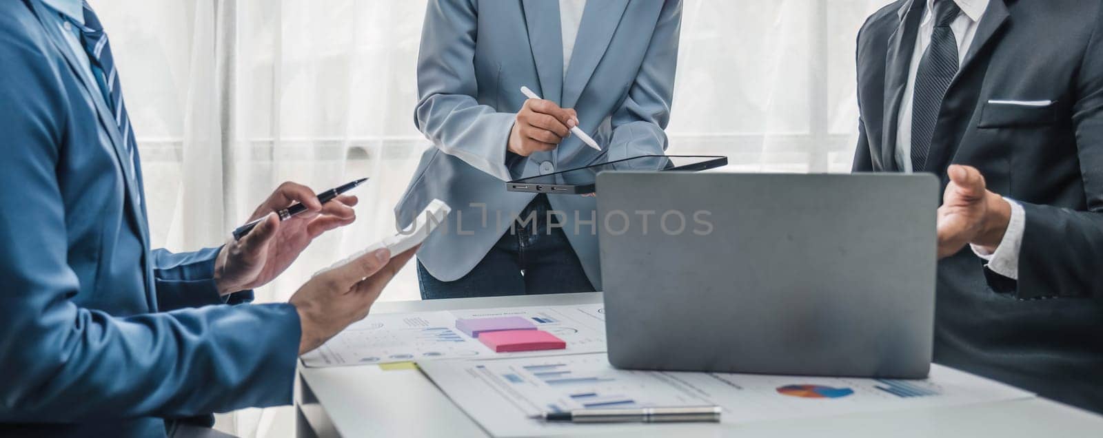 Business People Meeting using laptop computer,calculator,notebook,stock market chart paper for analysis Plans to improve quality next month. Conference Discussion Corporate Concept...