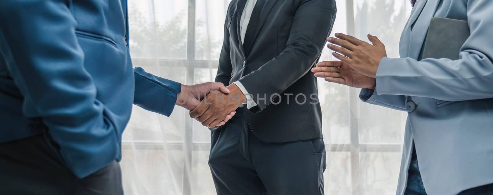 Business handshake for teamwork of business merger and acquisition,successful negotiate,hand shake,two businessman shake hand with partner to celebration partnership and business deal concept