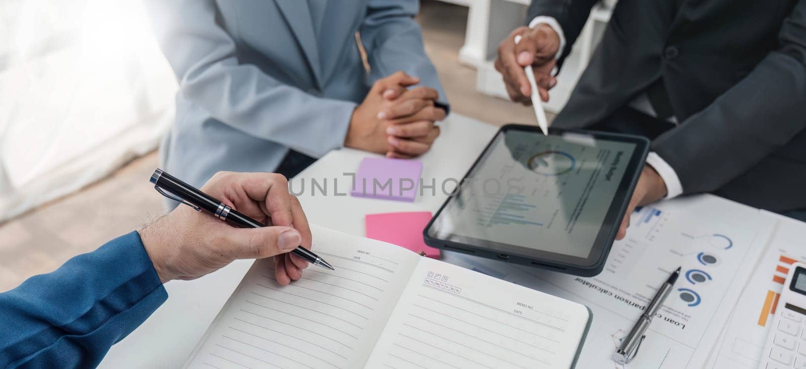 Business People Meeting using laptop computer,calculator,notebook,stock market chart paper for analysis Plans to improve quality next month. Conference Discussion Corporate Concept. by wichayada