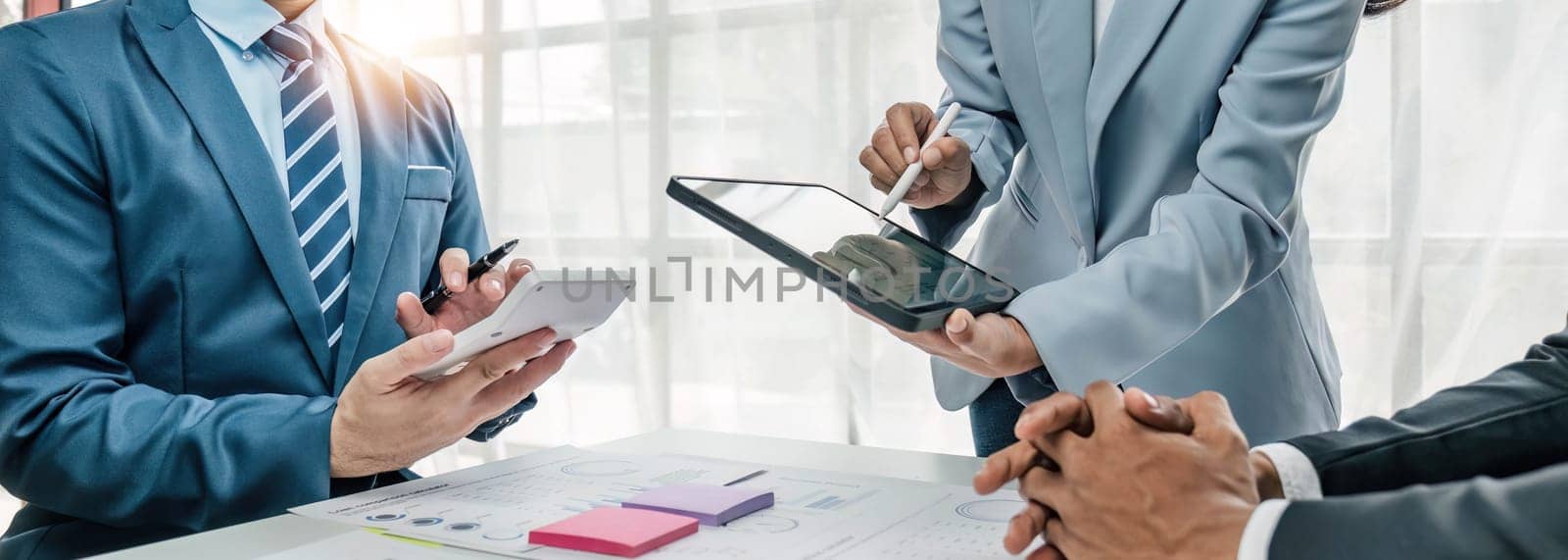 Business People Meeting using laptop computer,calculator,notebook,stock market chart paper for analysis Plans to improve quality next month. Conference Discussion Corporate Concept...