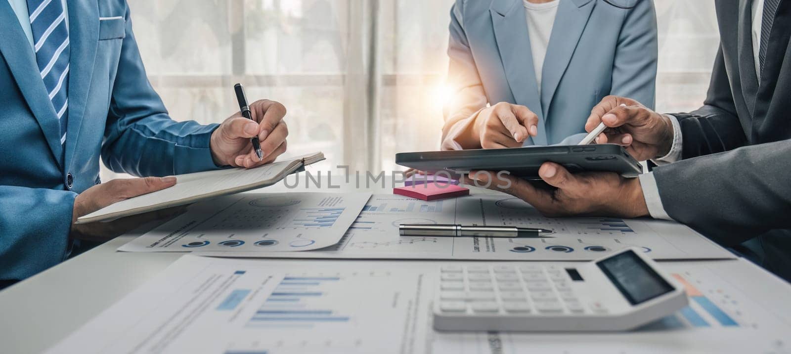 Business People Meeting using laptop computer,calculator,notebook,stock market chart paper for analysis Plans to improve quality next month. Conference Discussion Corporate Concept. by wichayada