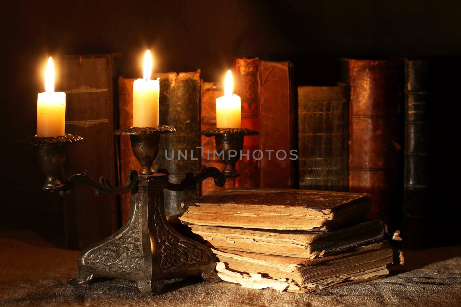 Nice vintage candlestick on background with old books