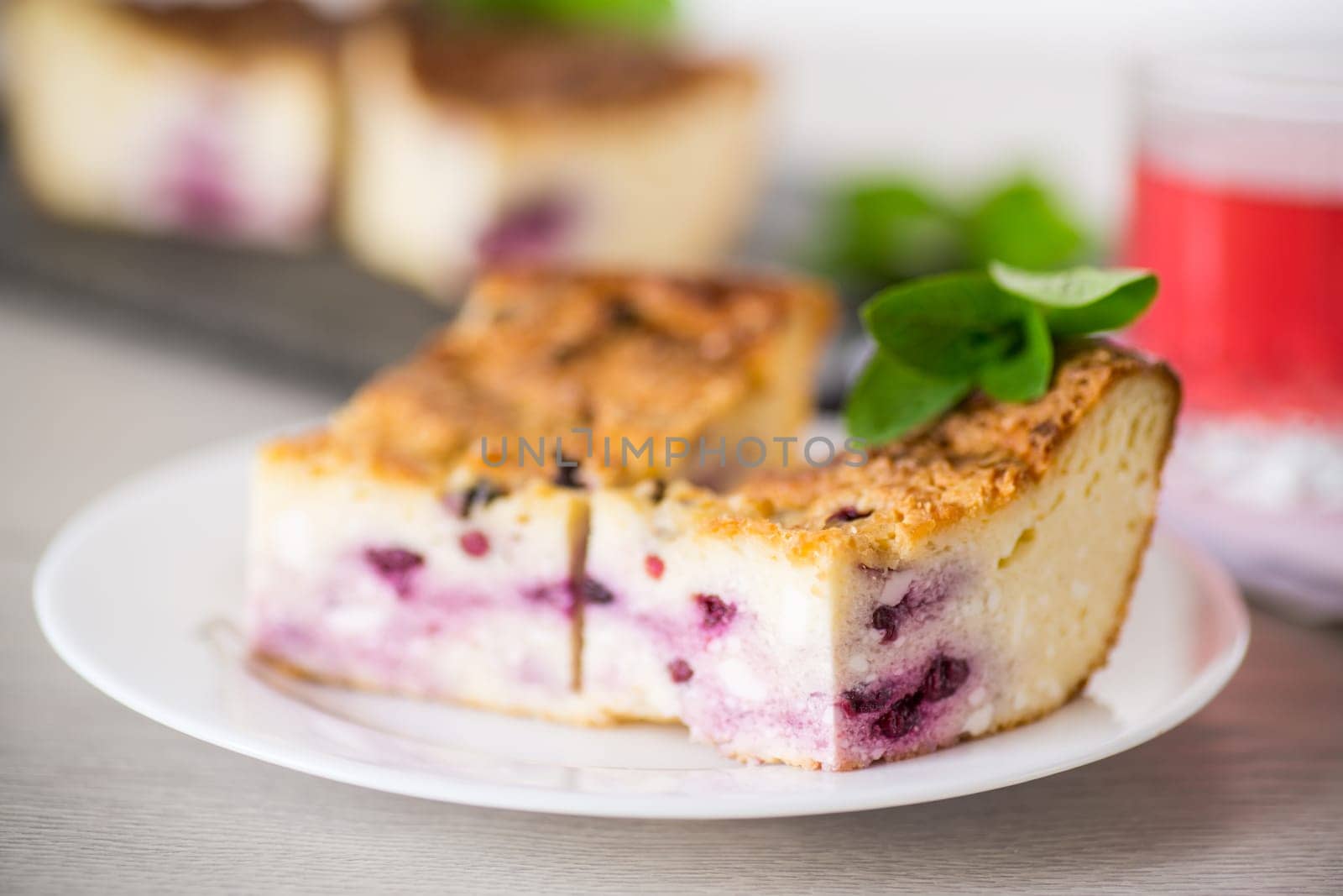 cooked cottage cheese casserole with berry filling in a plate by Rawlik