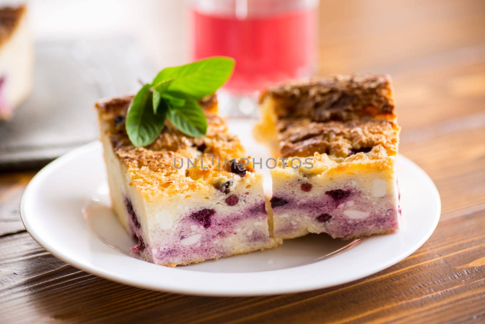 cooked cottage cheese casserole with berry filling in a plate by Rawlik