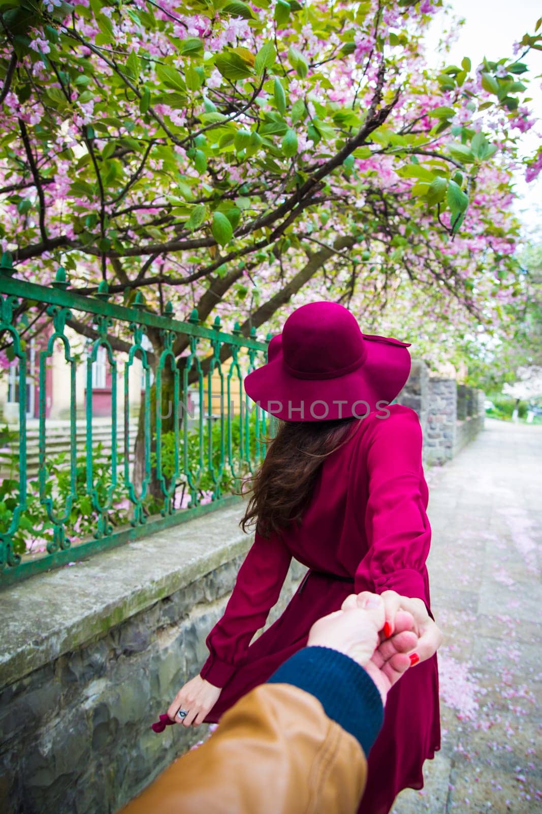 rear view - Woman holding the hand of man