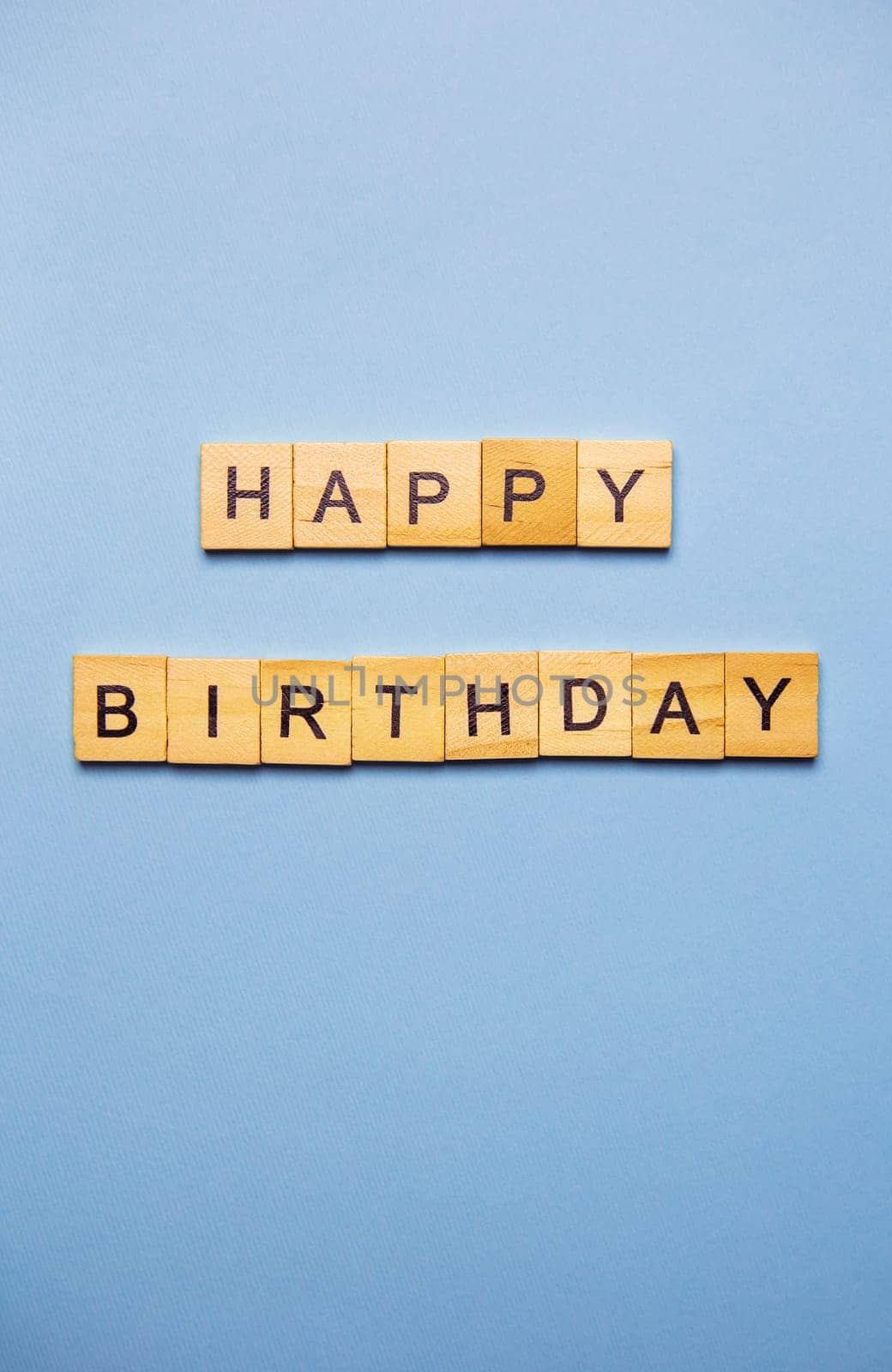 Happy birthday party, blue background with wooden text happy birthday. Ready postcard. Place for an inscription