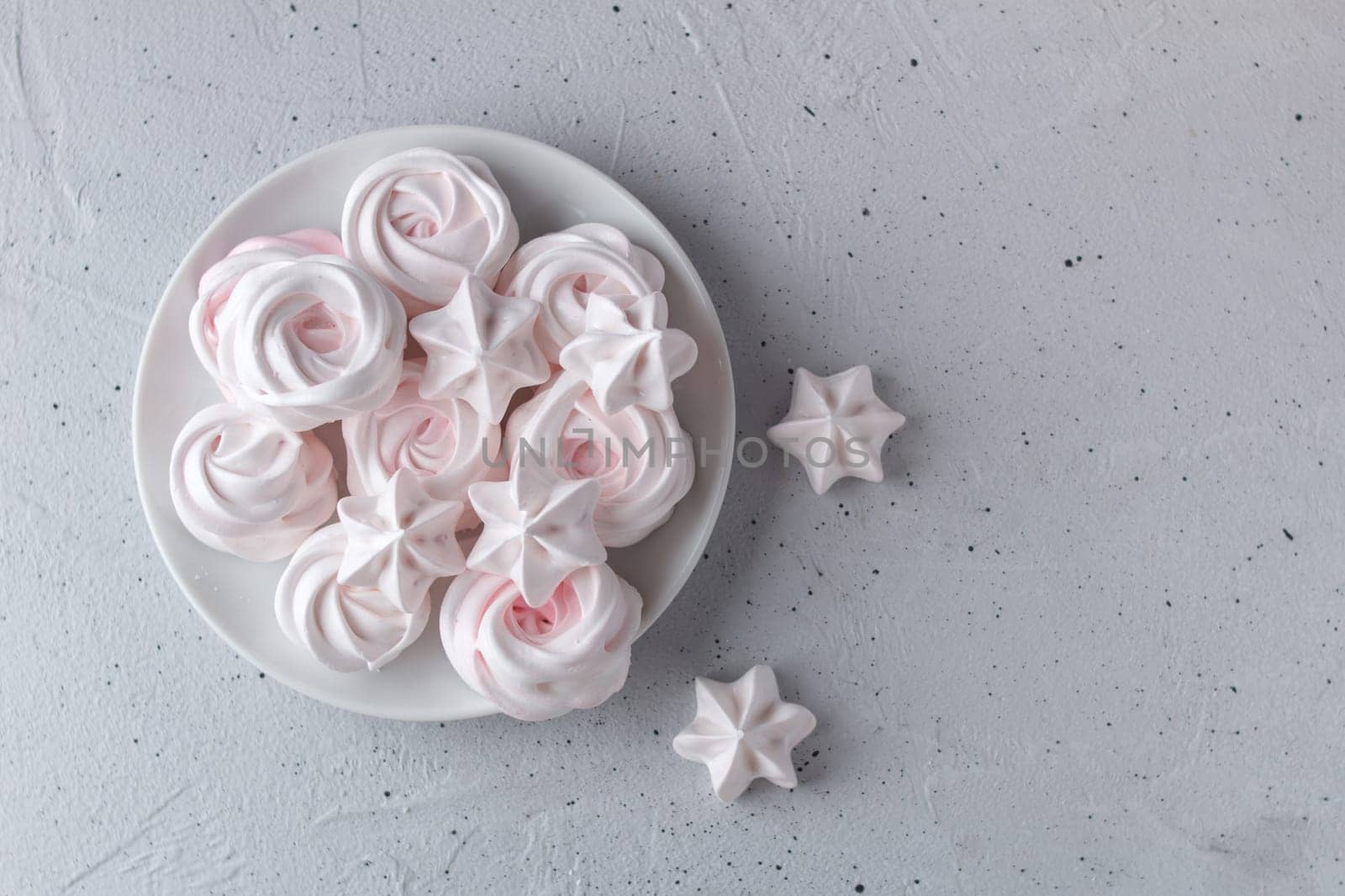 Meringue. Light dessert of whipped egg whites on a gray background. copy space by lara29