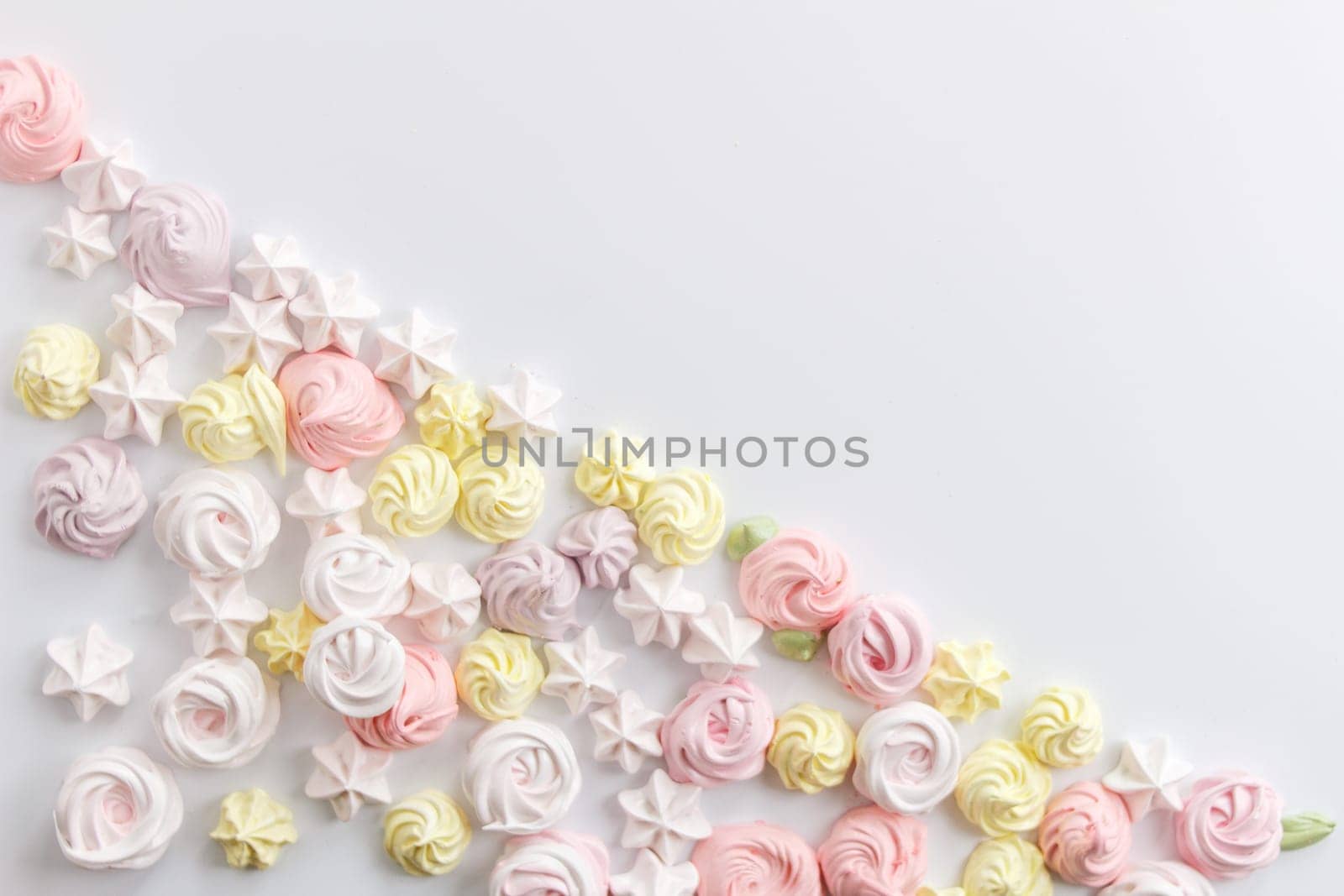 Meringue. Light dessert of whipped egg whites on a white background. copy space