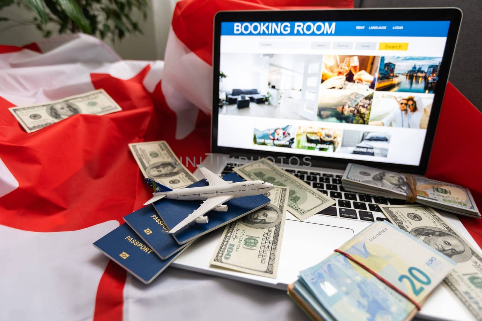 laptop with travel, money and canada flag by Andelov13