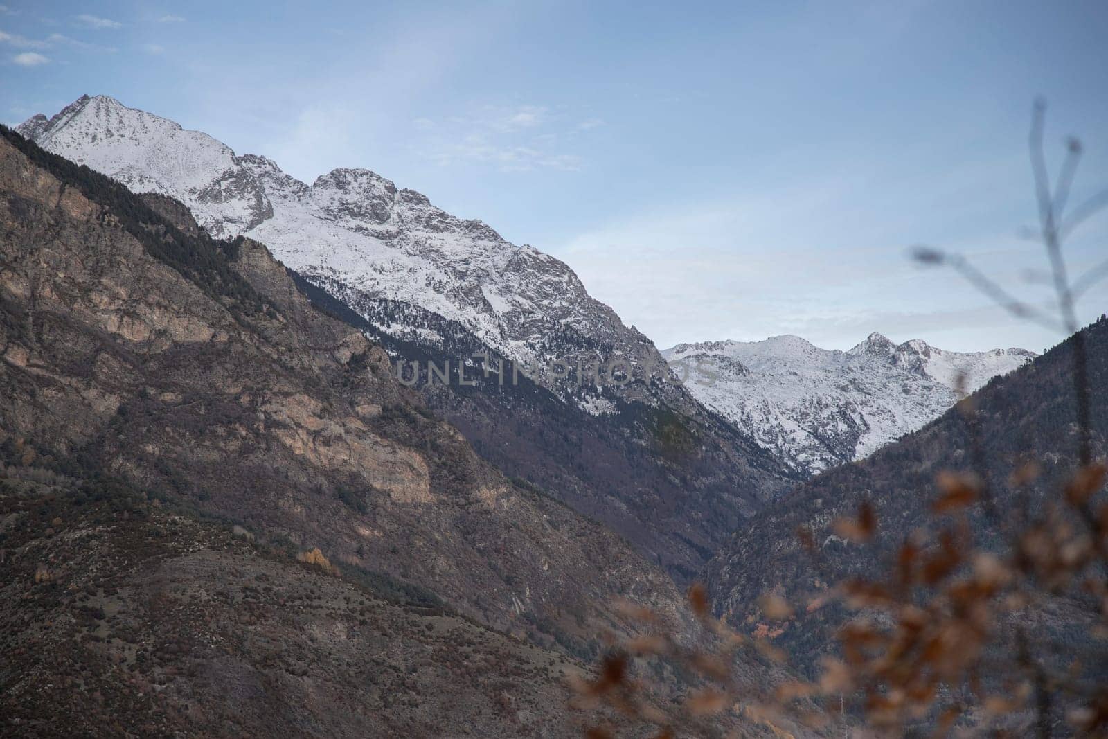 Snowy mountains under cloudy sky landscape in Boi Valley in Pyrenees in Catalonia