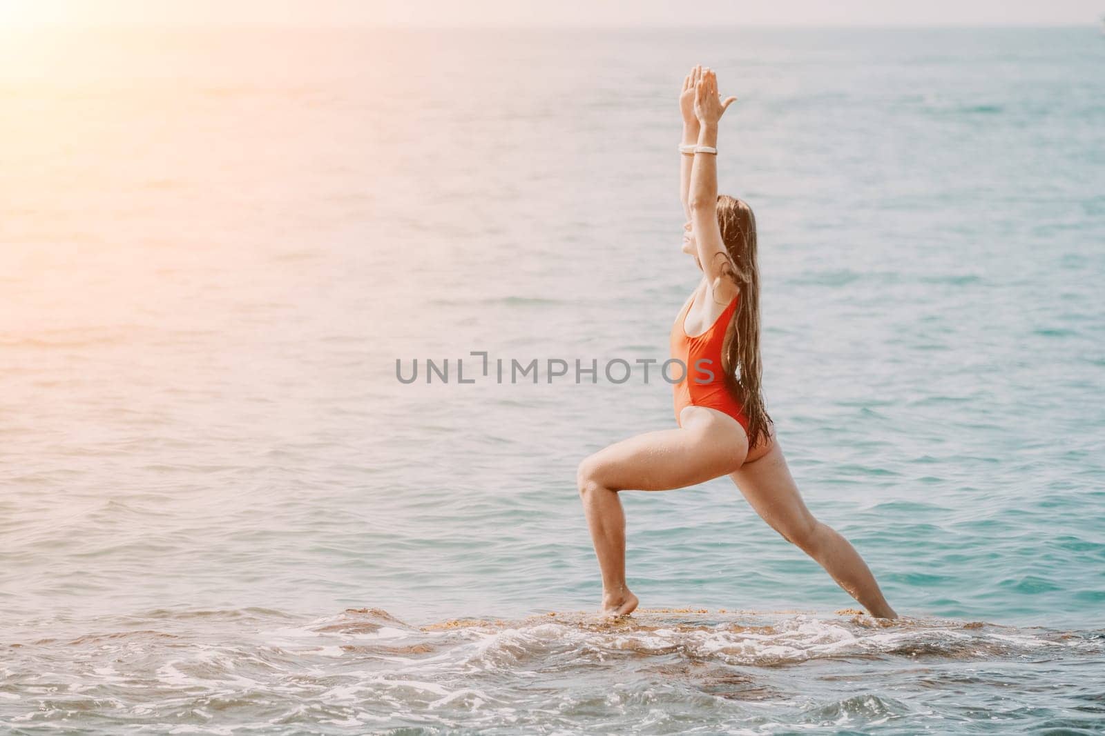 Woman sea yoga. Happy woman meditating in yoga pose on the beach, ocean and rock mountains. Motivation and inspirational fit and exercising. Healthy lifestyle outdoors in nature, fitness concept. by panophotograph