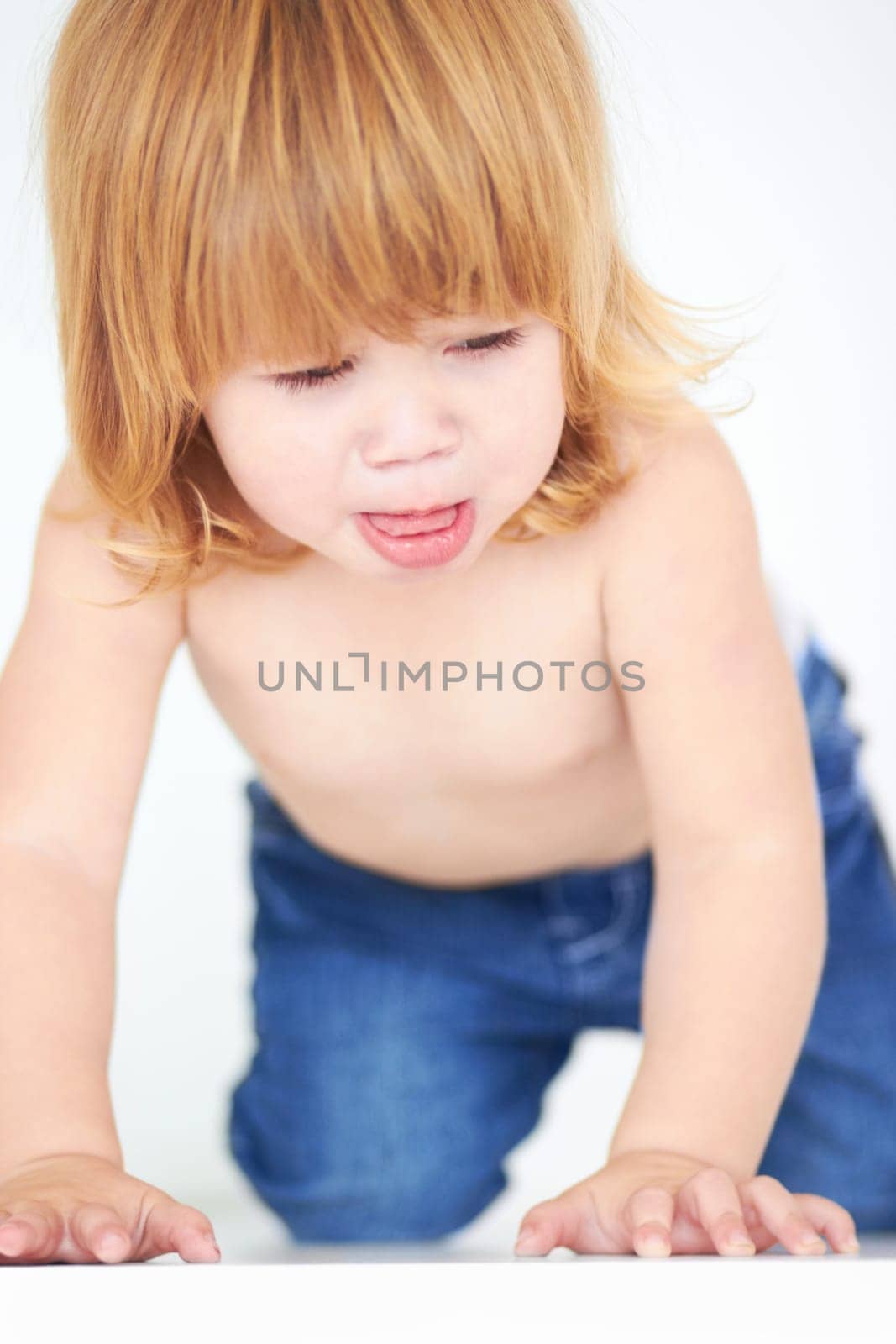 Cute, crawling and learning with baby on floor for curious, sweet and child development. Growth, youth and health and adorable with young toddler on ground in studio for childhood, innocent or active by YuriArcurs