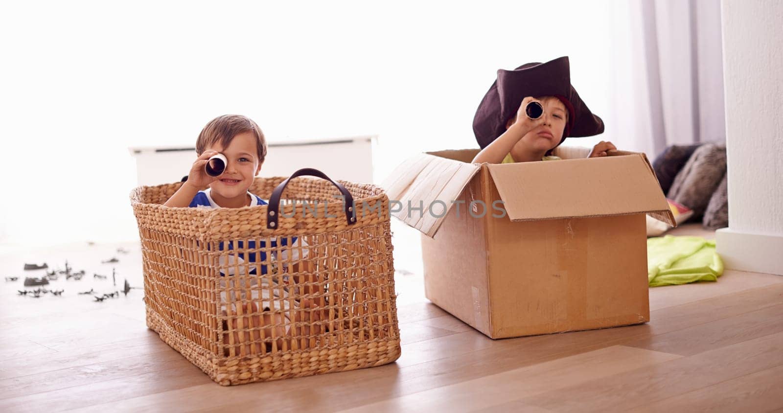 Fantasy, children smile in costume as pirate and play with boat boxes in living room at their home. Happiness, creative and an adventure game with happy or excited kids pretending to sail on a ship.