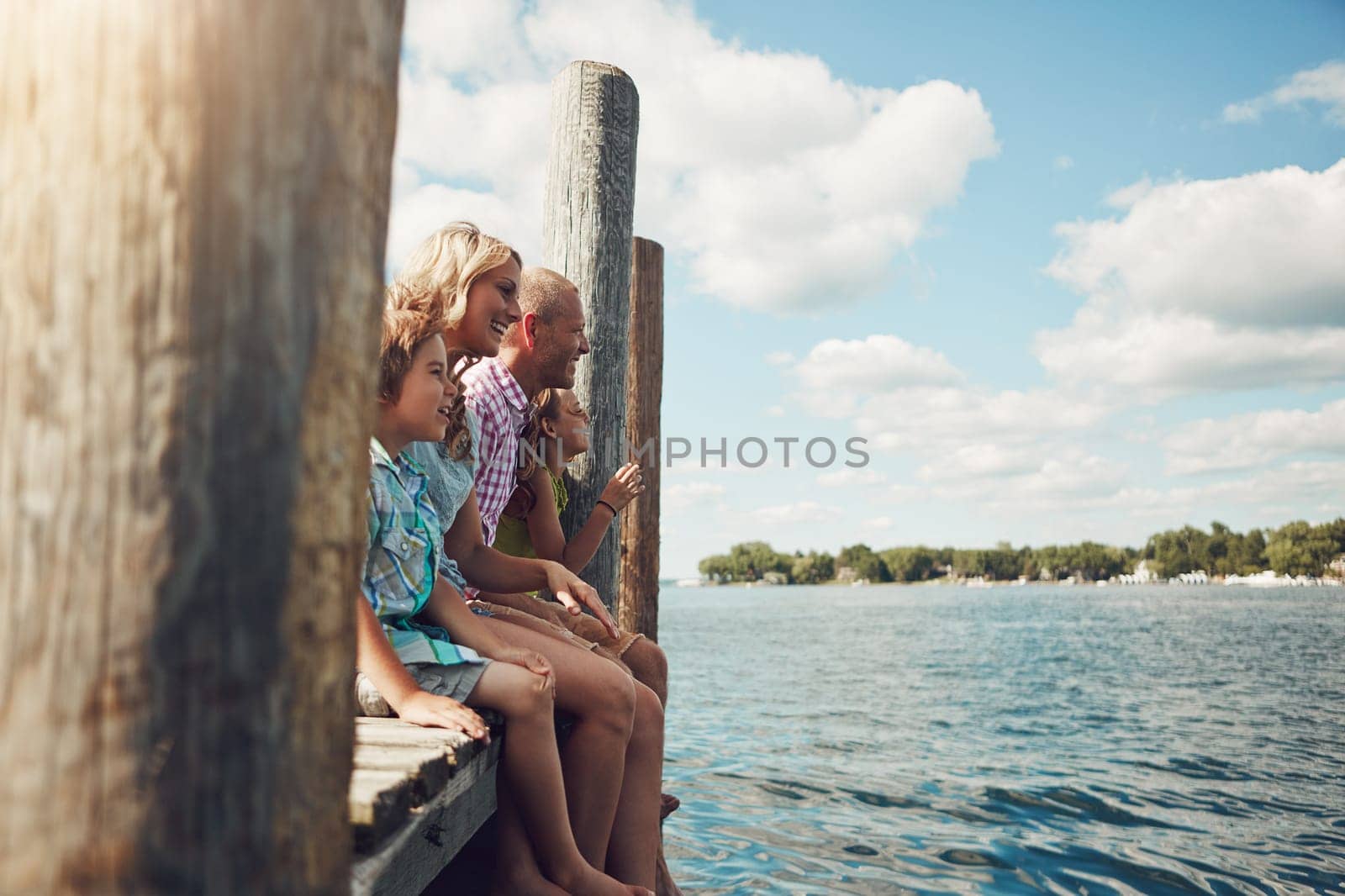 Family is a great adventure. a young family on a pier while out by the lake