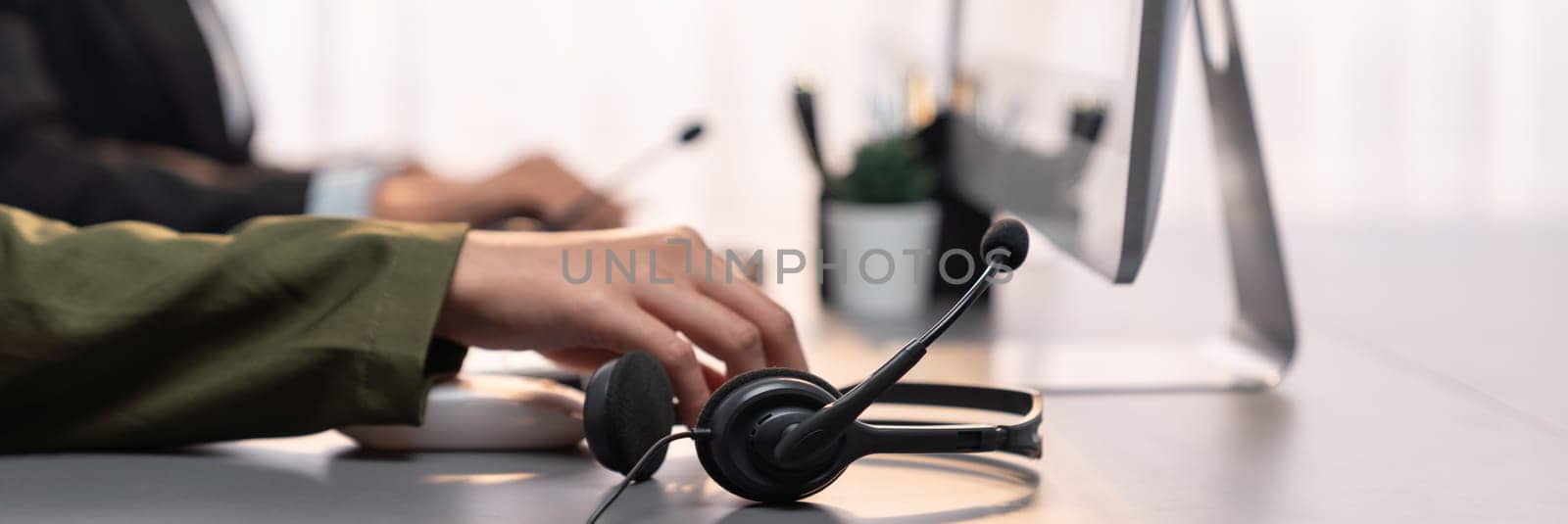 Panorama focus headset on call center workspace desk with blur operator. Prodigy by biancoblue