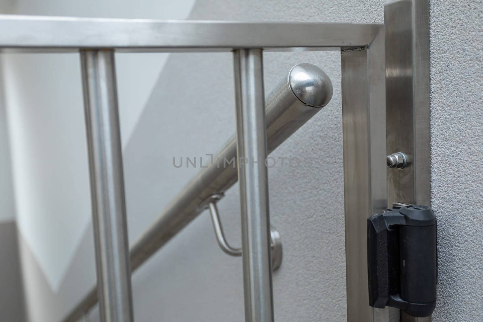 Close-up view of how the railing was made and attached, along with the post and handrail. The enclosure is made of acid-resistant stainless steel.