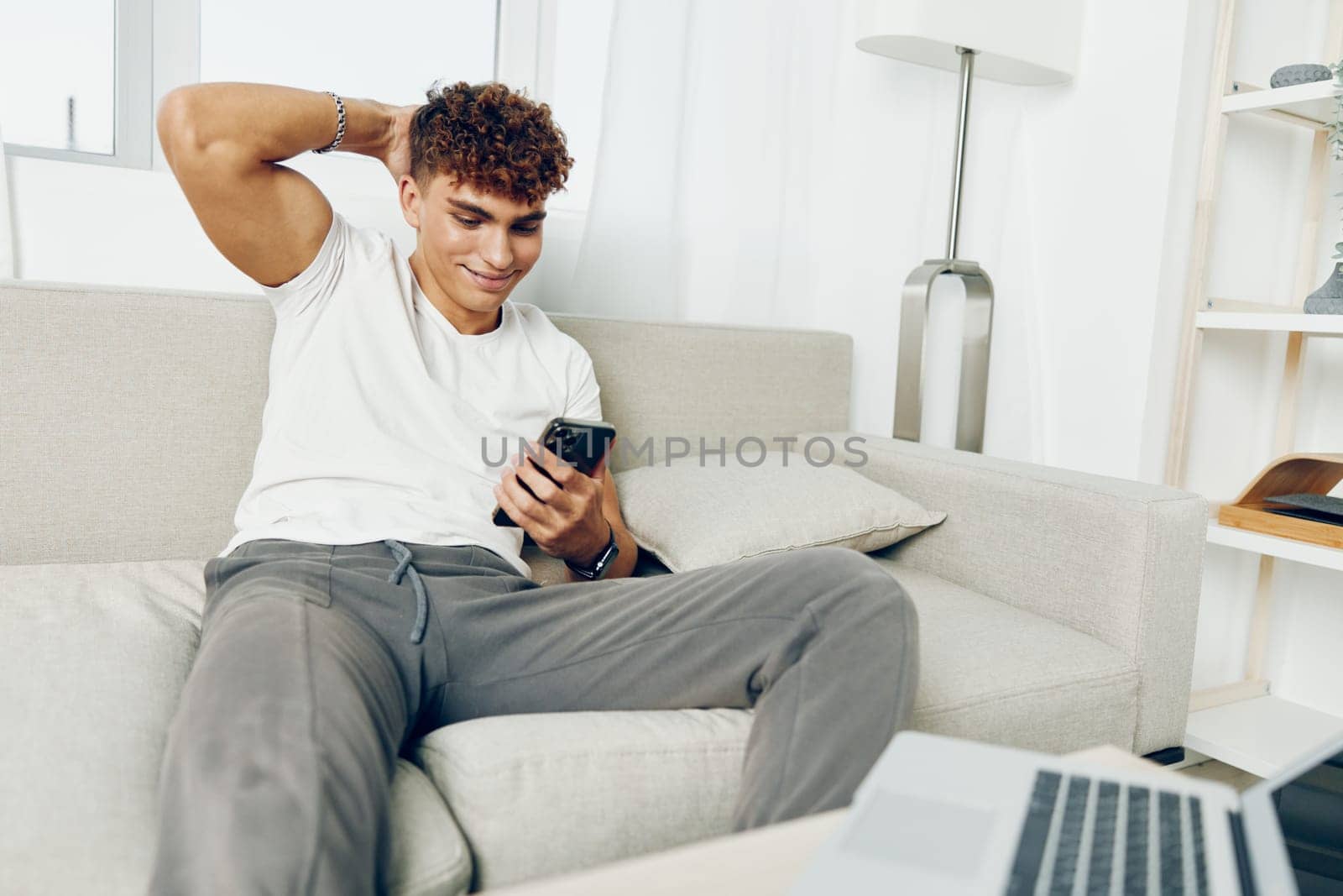 man mobile modern technology lifestyle cyberspace text message phone laptop blogger blissful young