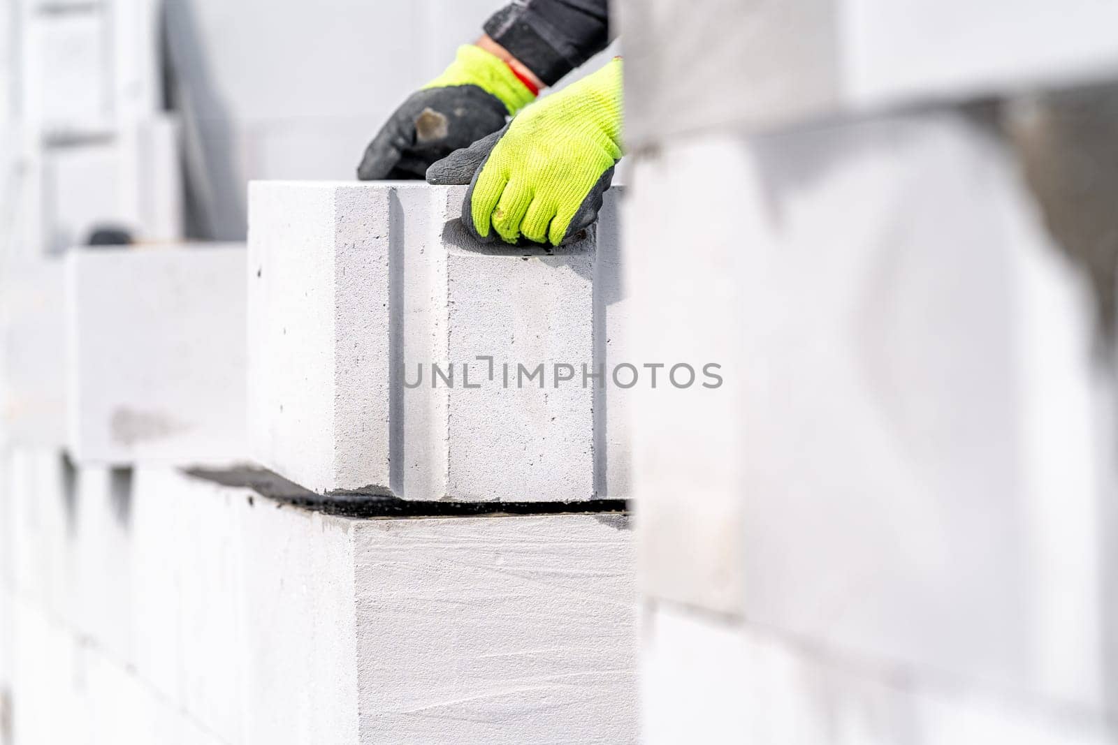 construction of a wall of a house made of concrete bricks by Edophoto