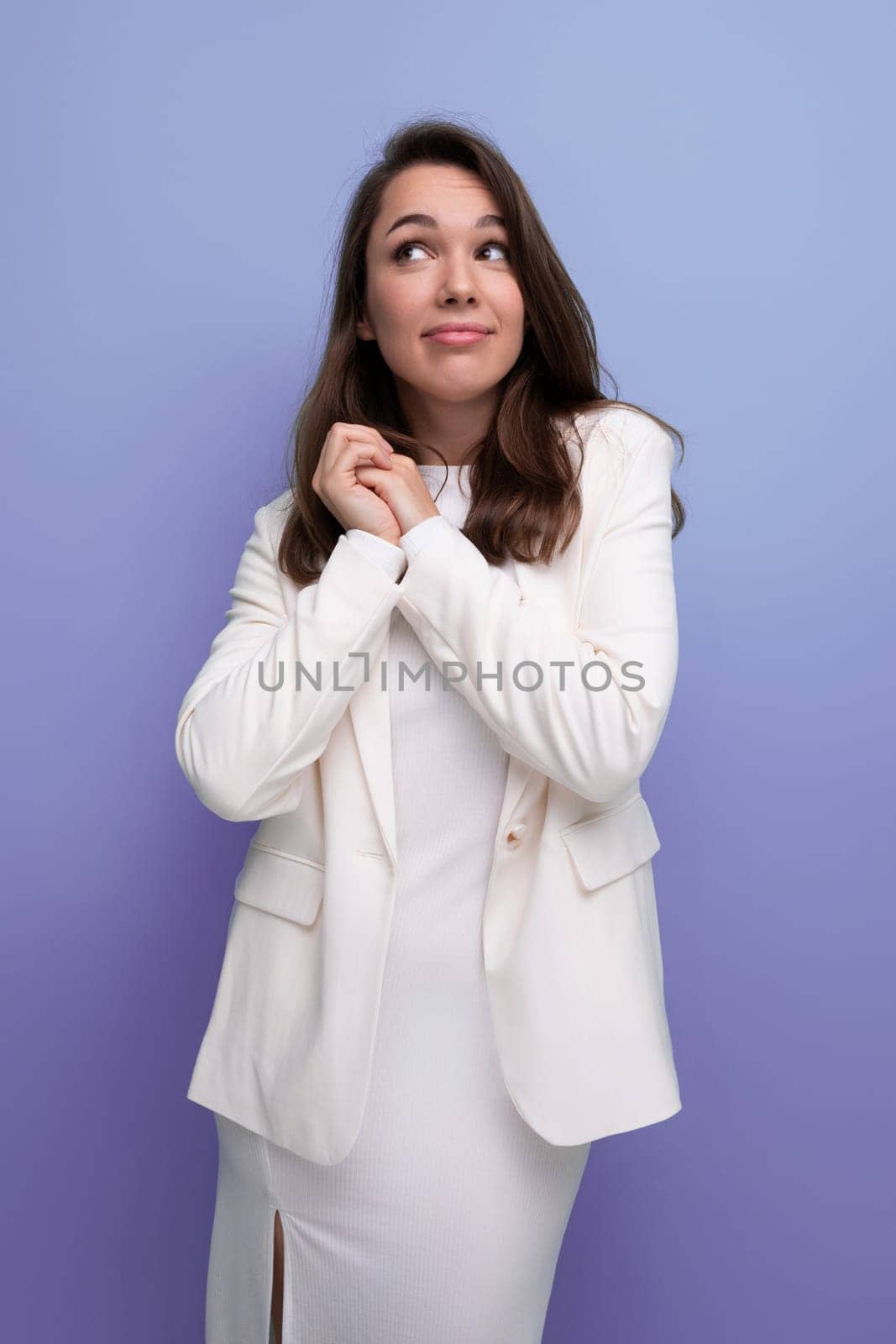 portrait of a well-groomed caucasian brunette woman in a white dress.