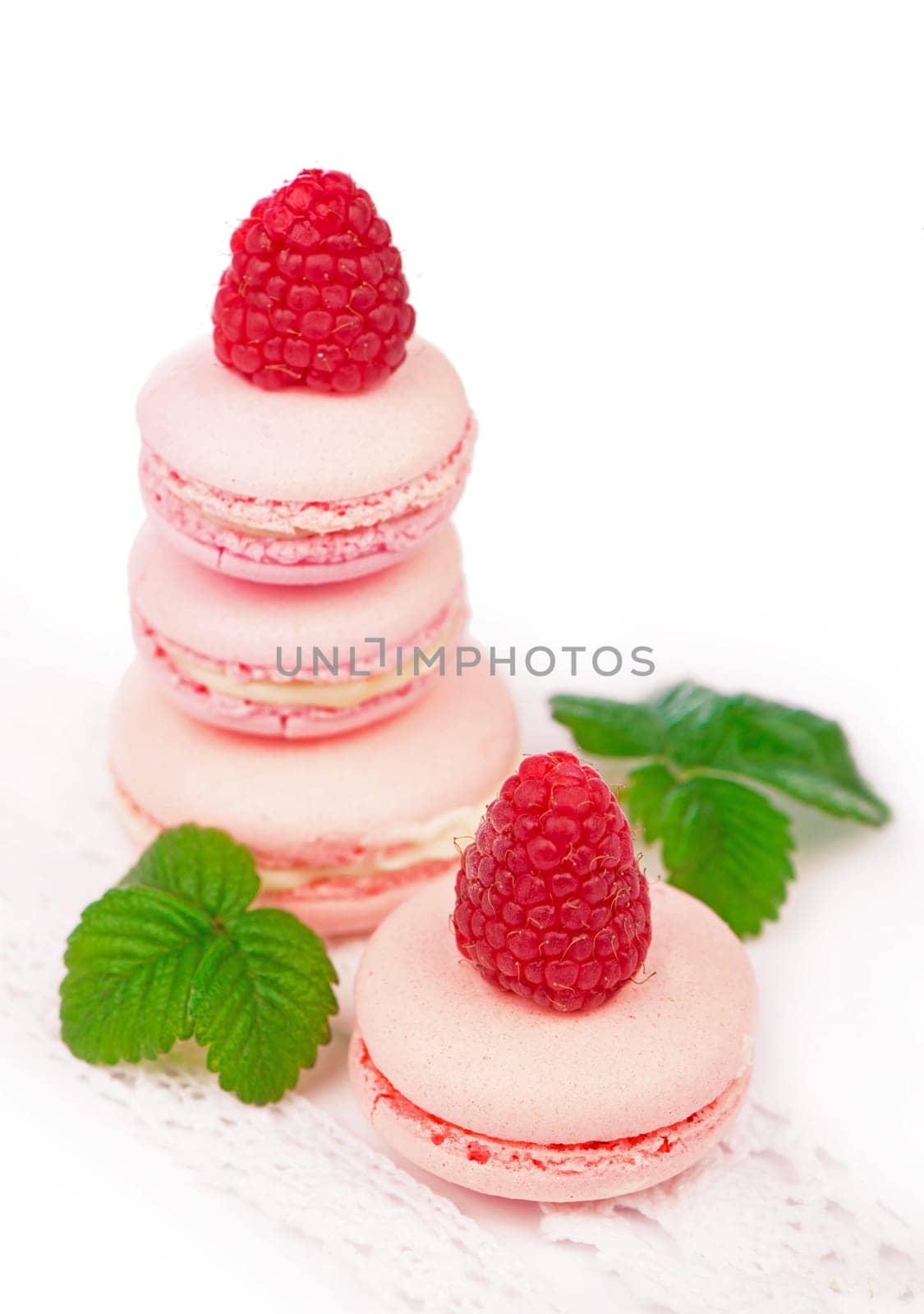 French makarons cake . Pink raspberry macaron cookies. Isolated on white background by aprilphoto
