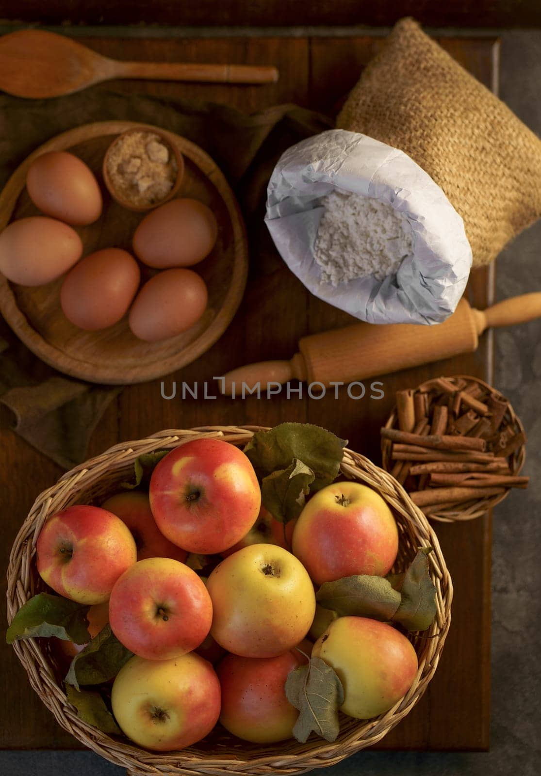 preparation to bake an apple pie on a wooden table by aprilphoto