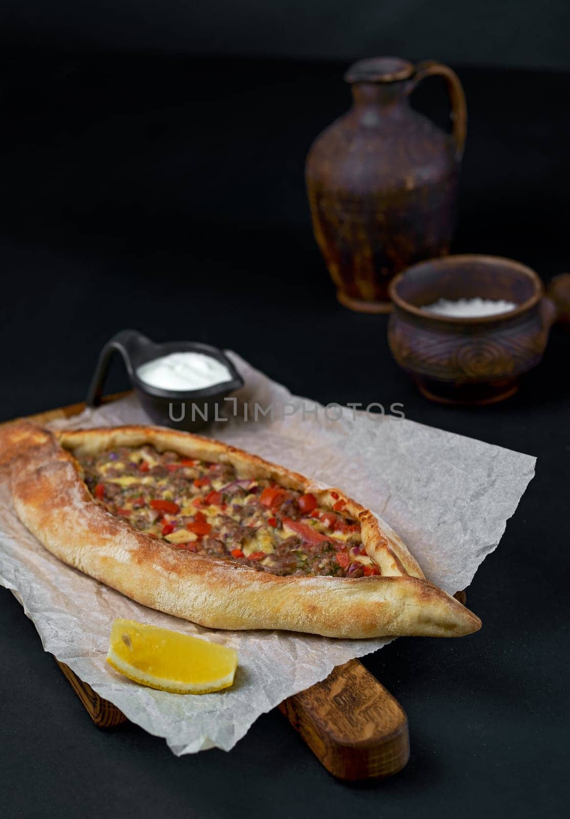 Traditional Georgian pastry - Adjarian khachapuri with cheese and vegetables Khachapuri on a wooden background in a rustic style. Khachapuri with ingredients.