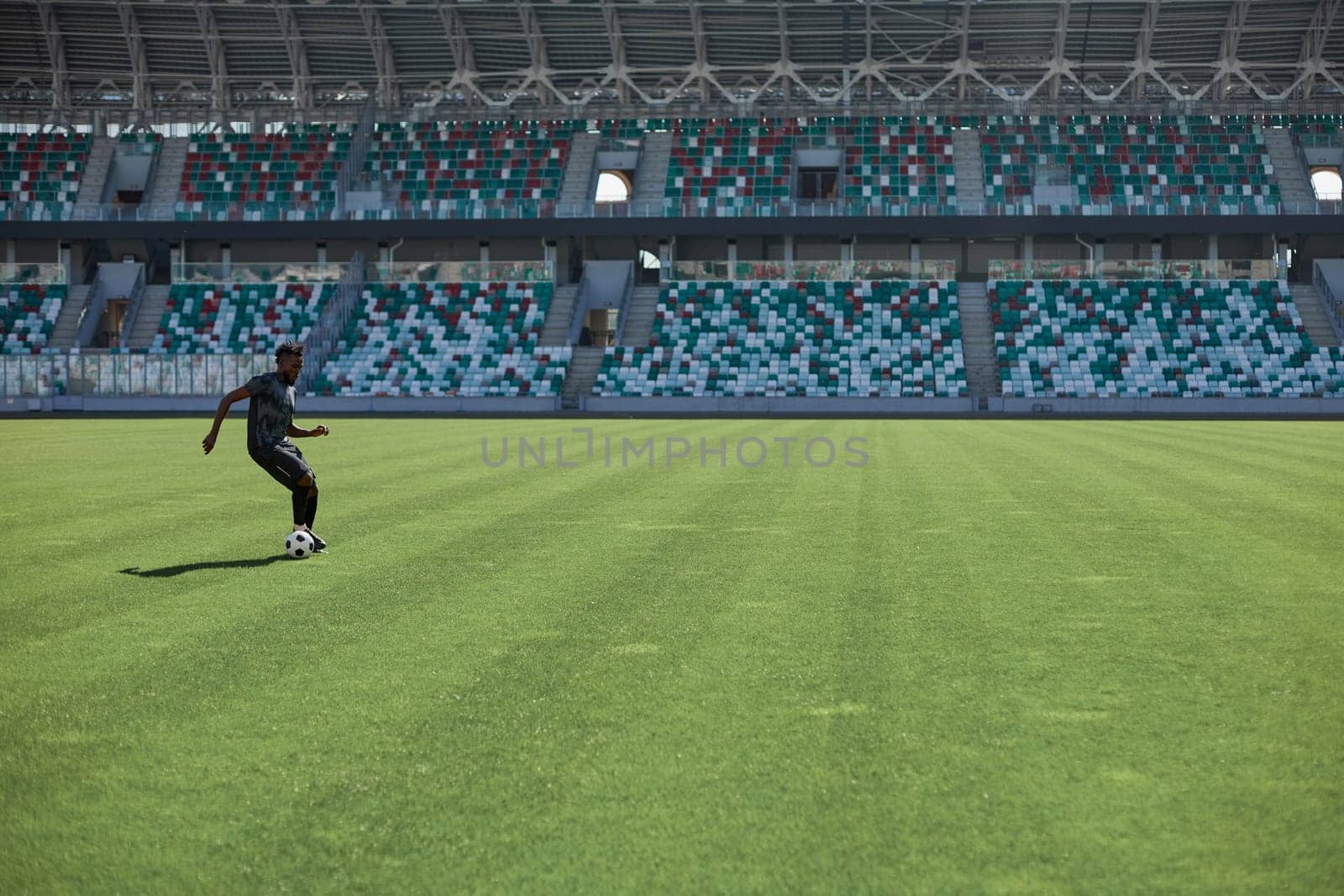 Professional football player in action at the stadium. The concept of sport, competition, movement, overcoming. The effect of the presence of the field.