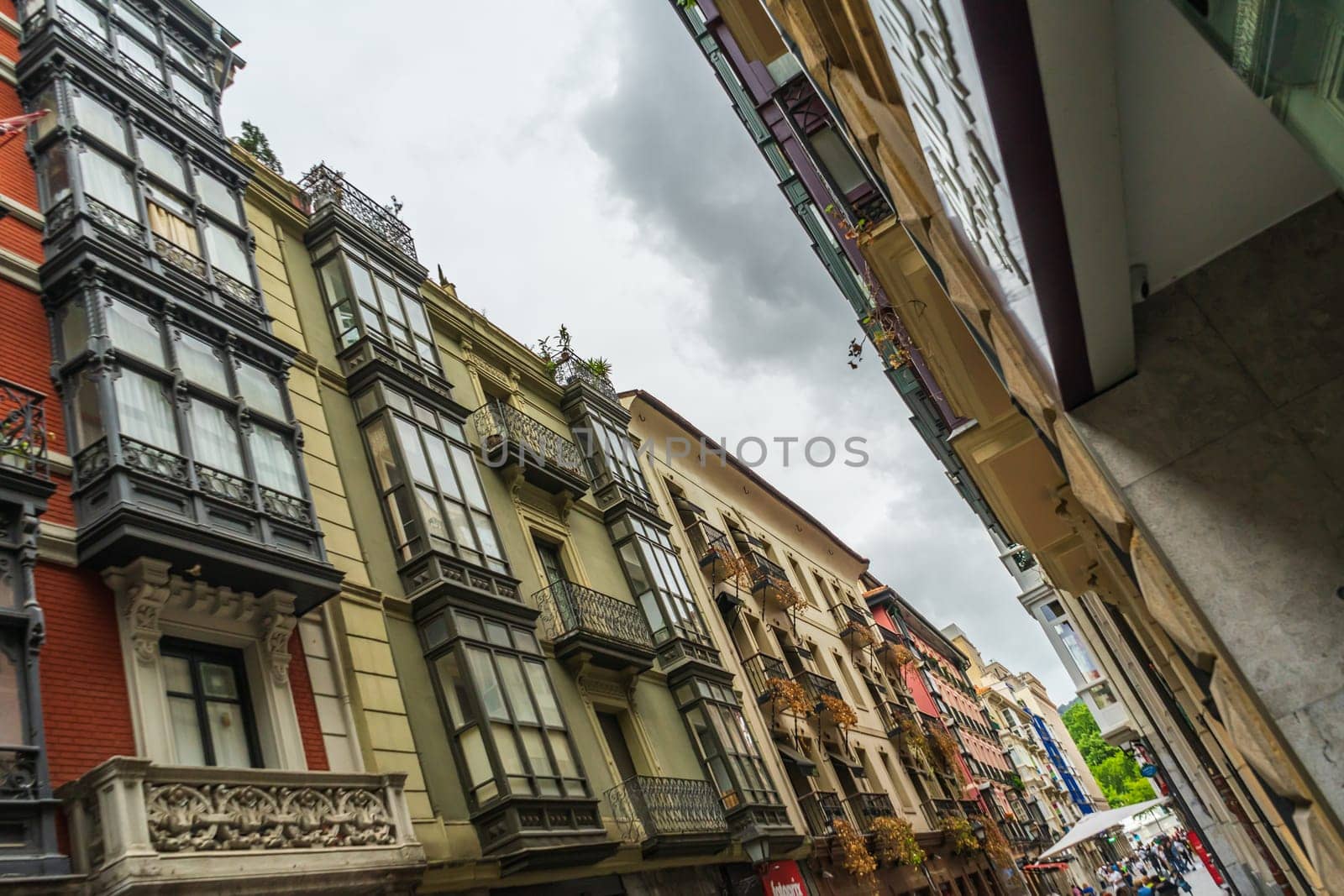 Bilbao, Spain - 10.06.2022: narrow streets with colorful balconies angle view