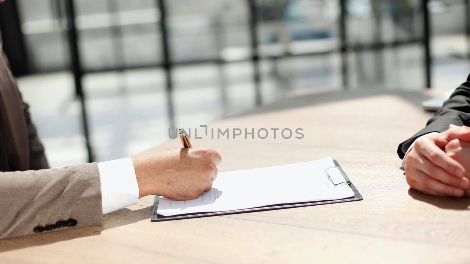Businessmen hand's pointing where to sign a contract, legal papers or application form.