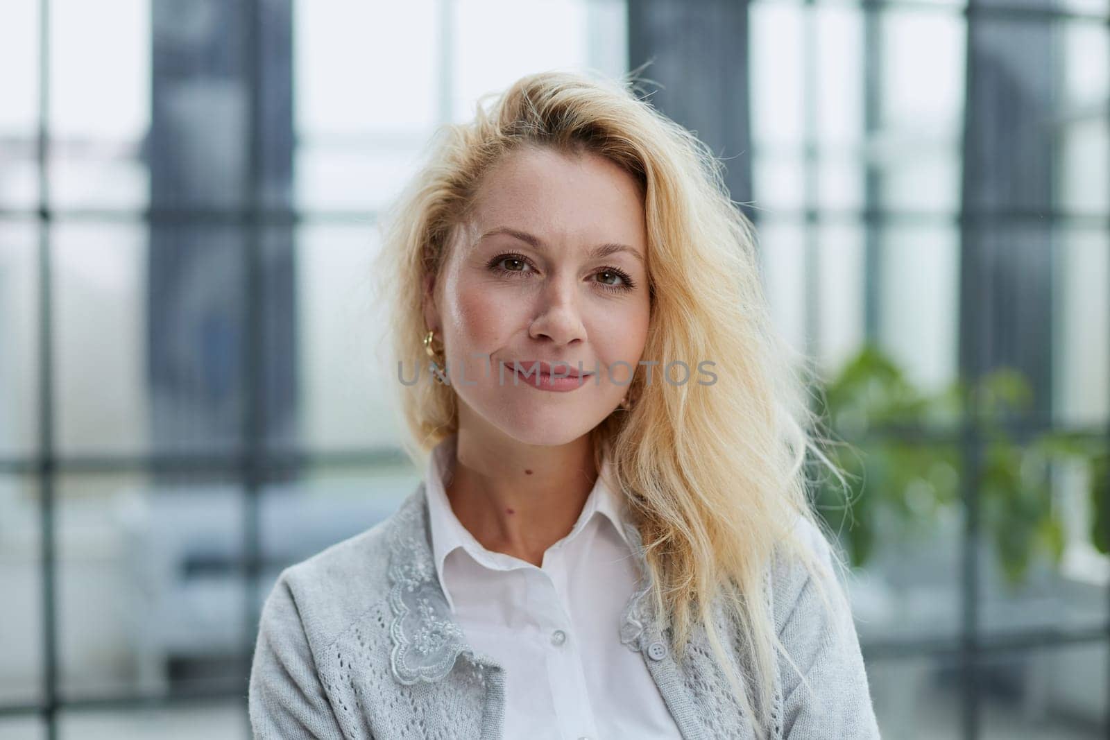 Attractive woman looking pensively at the camera in office