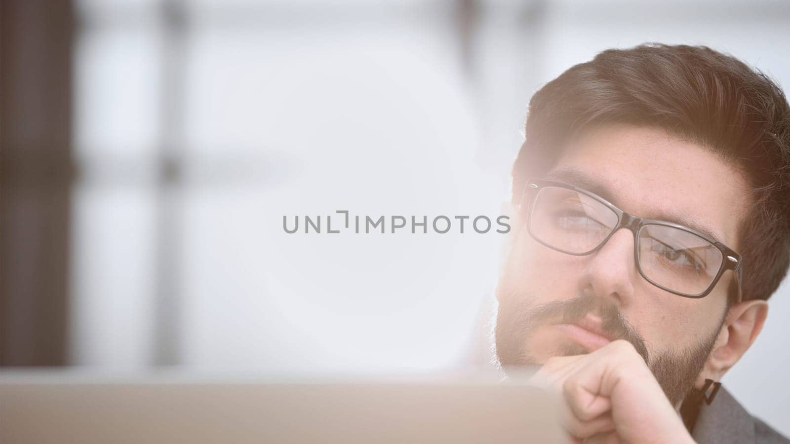 focused young businessman looking at computer monitor