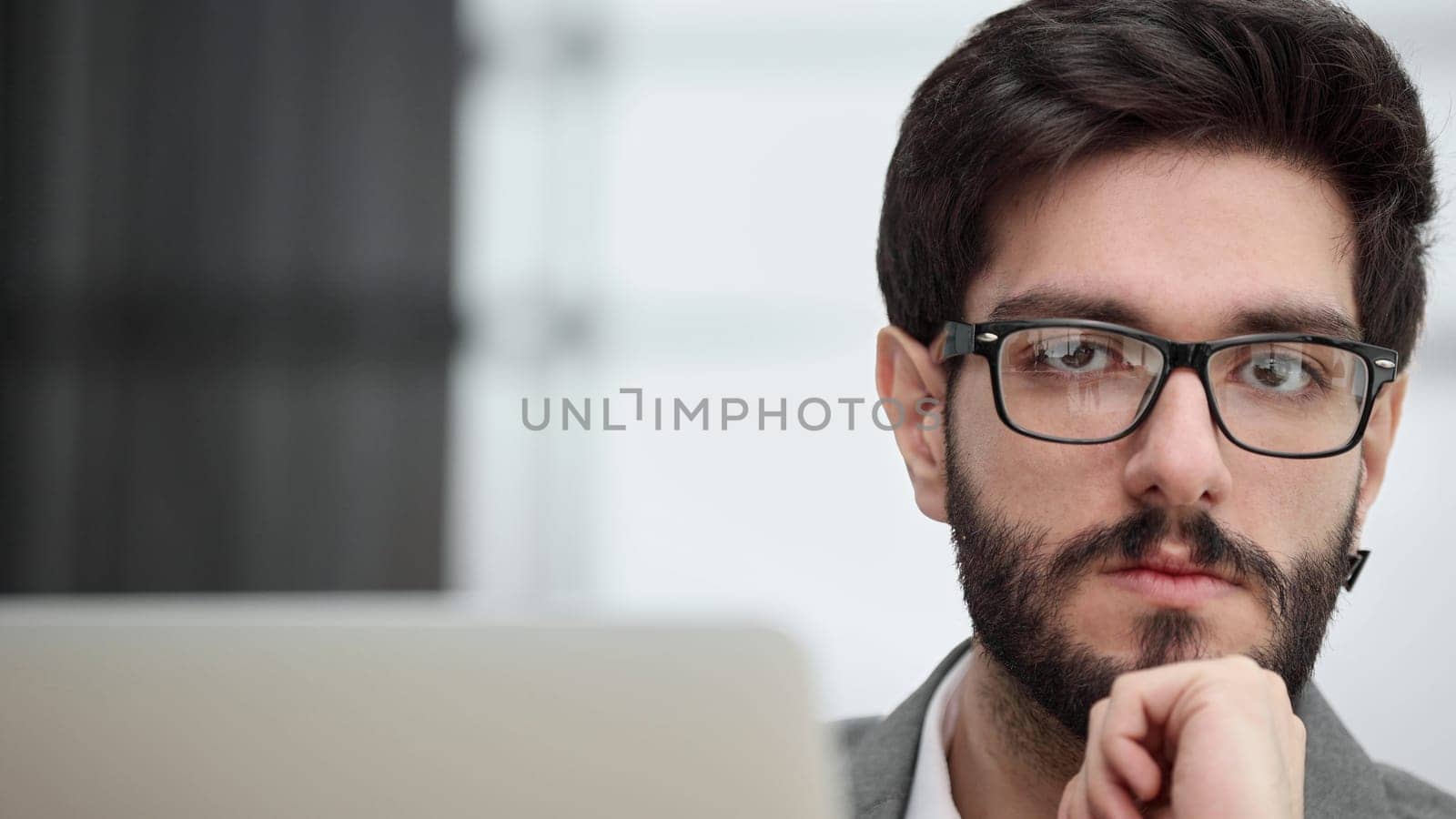 focused young businessman looking at computer monitor