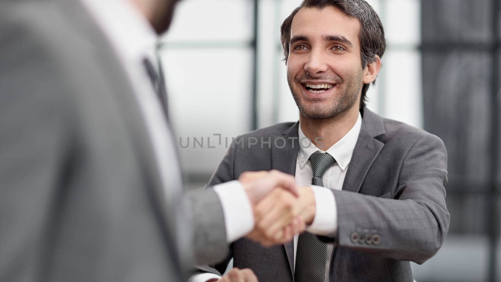 business man greets the employee with a handshake,