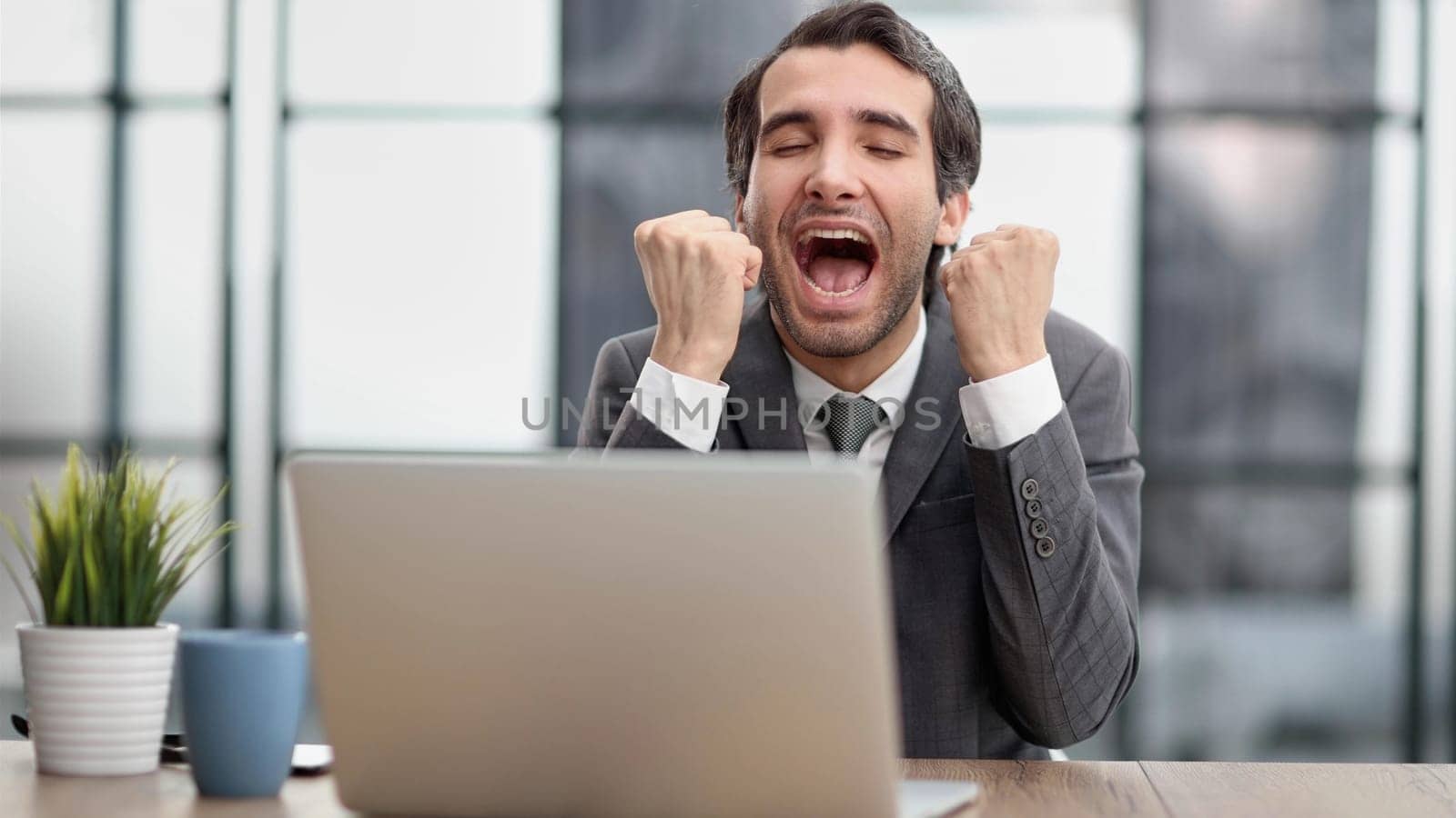 celebrating goal achievement winning online getting good news in email raising hands feeling euphoric.