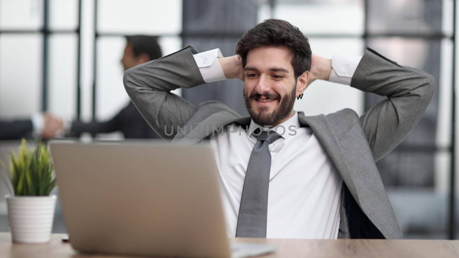 Young businessman your hands on the back of your head