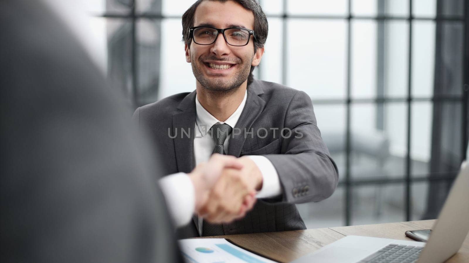 handshake of business partners at a meeting in the office