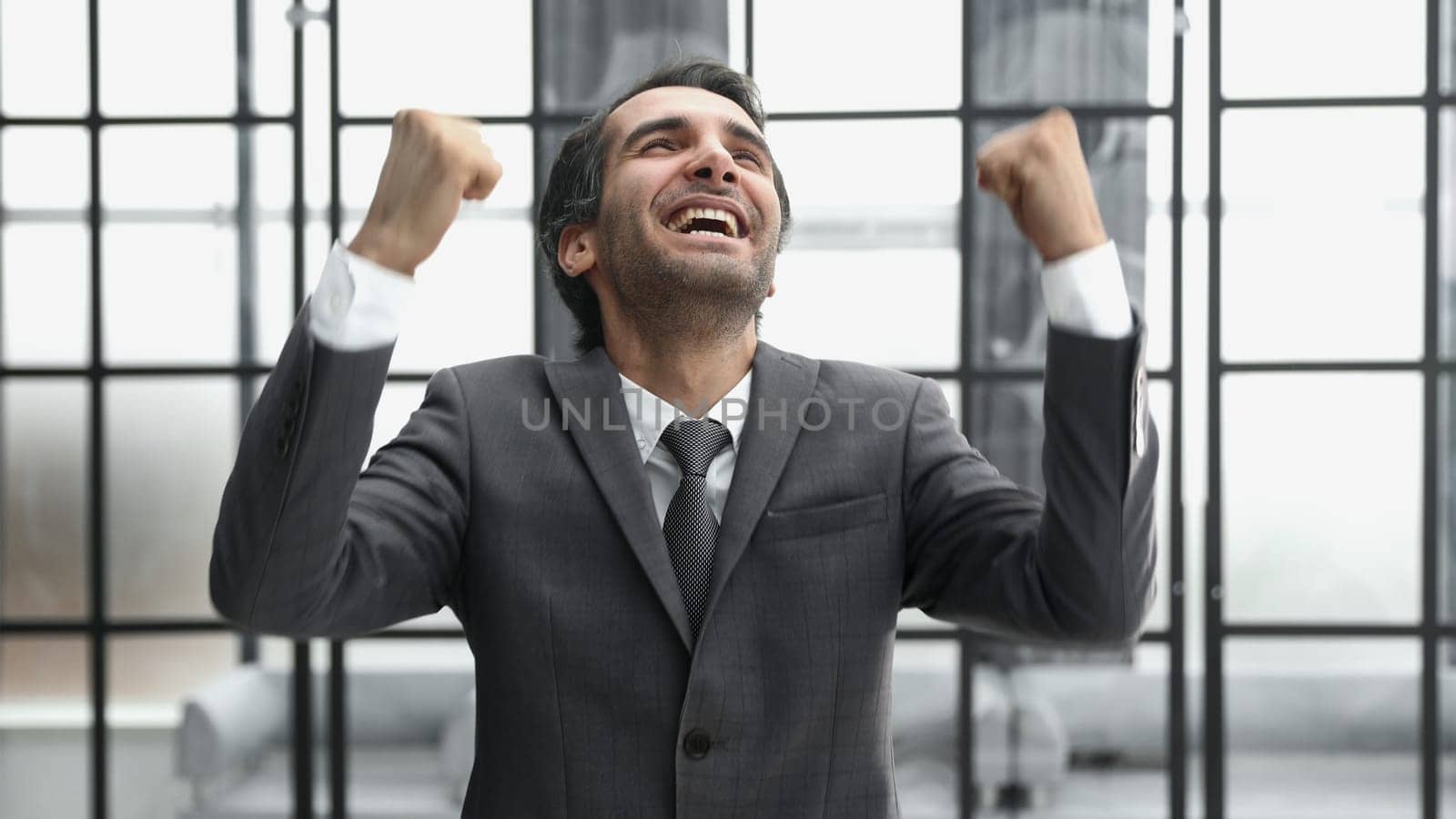 businessman with arms up celebrating his victory