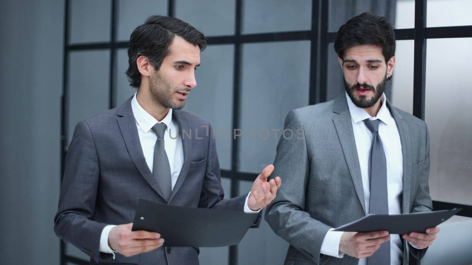 wo successful businesspeople while standing near office building