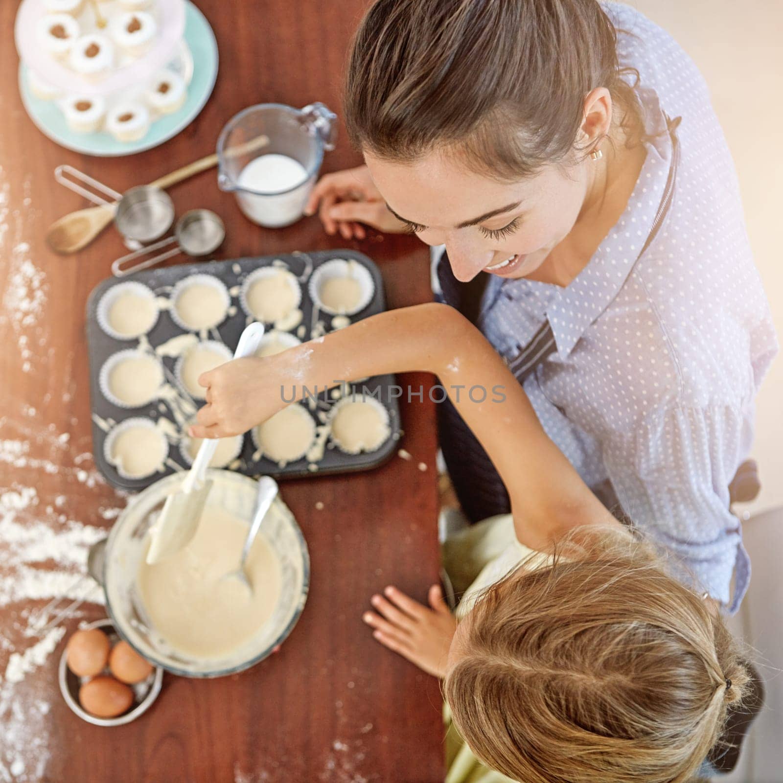 Youre my little baking star. a mother and her daughter baking in the kitchen. by YuriArcurs