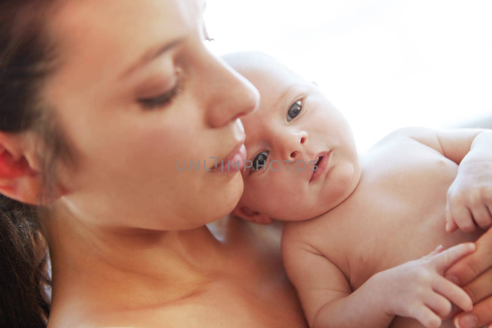 Relaxing with mom. Closeup shot of a mother holding her newborn baby