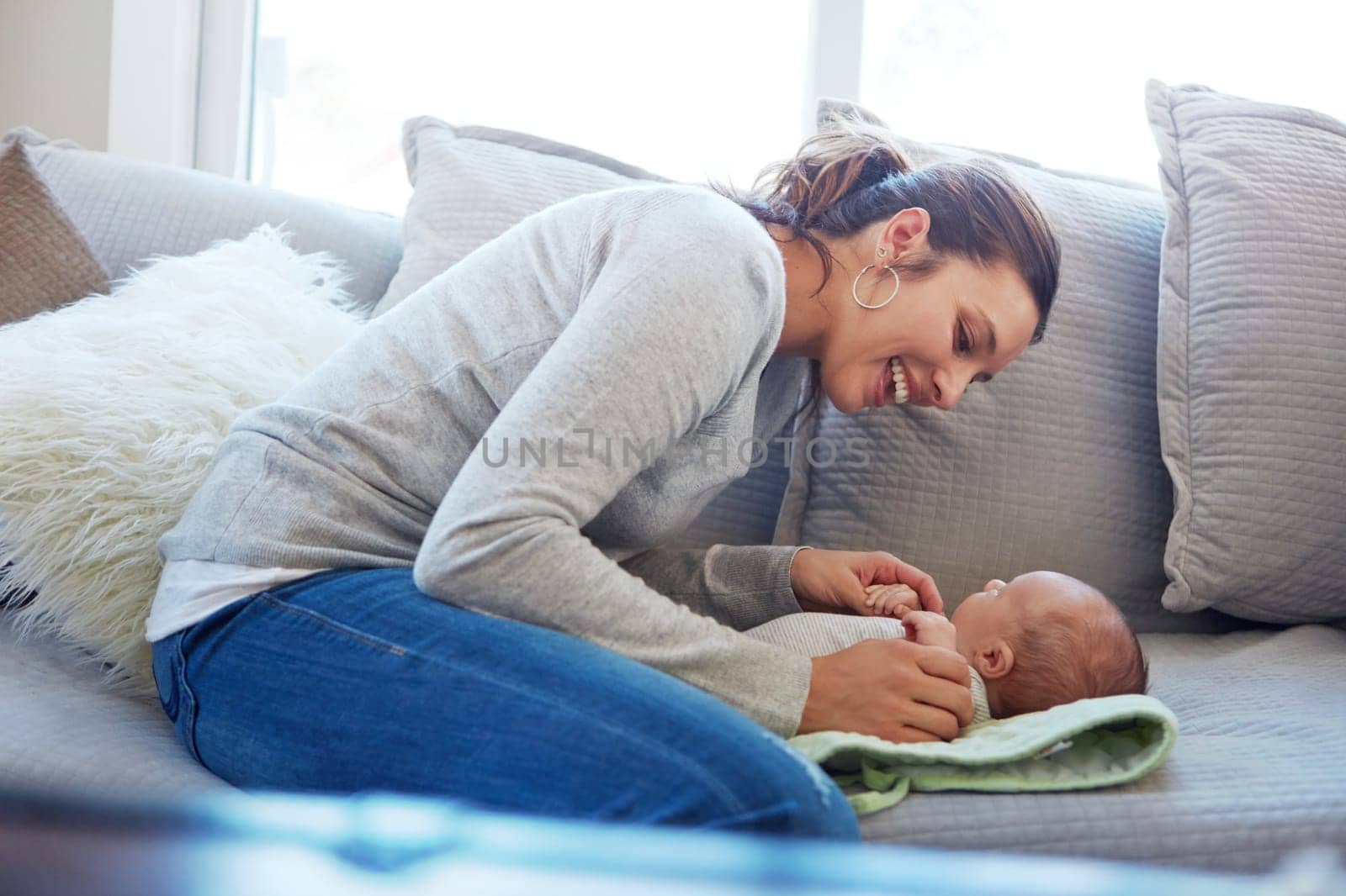 Hes the apple of my eye. a mother sitting with her newborn baby on a couch