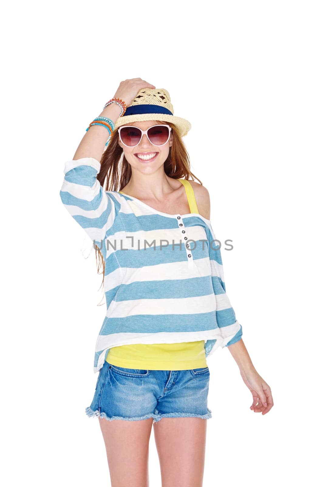 Dressed for summer fun. Studio shot of a young woman dressed for summer isolated on white