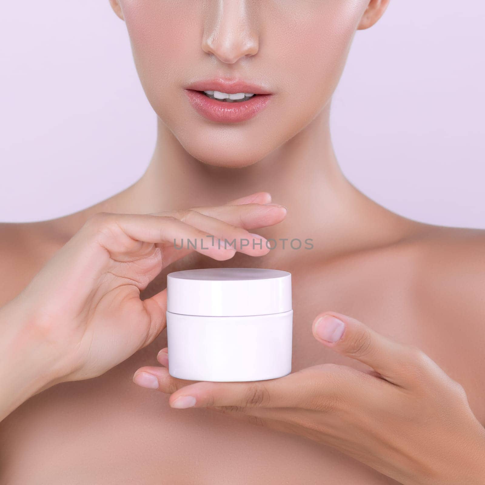 Alluring portrait of perfect skin woman holding mockup moisturizer jar. by biancoblue