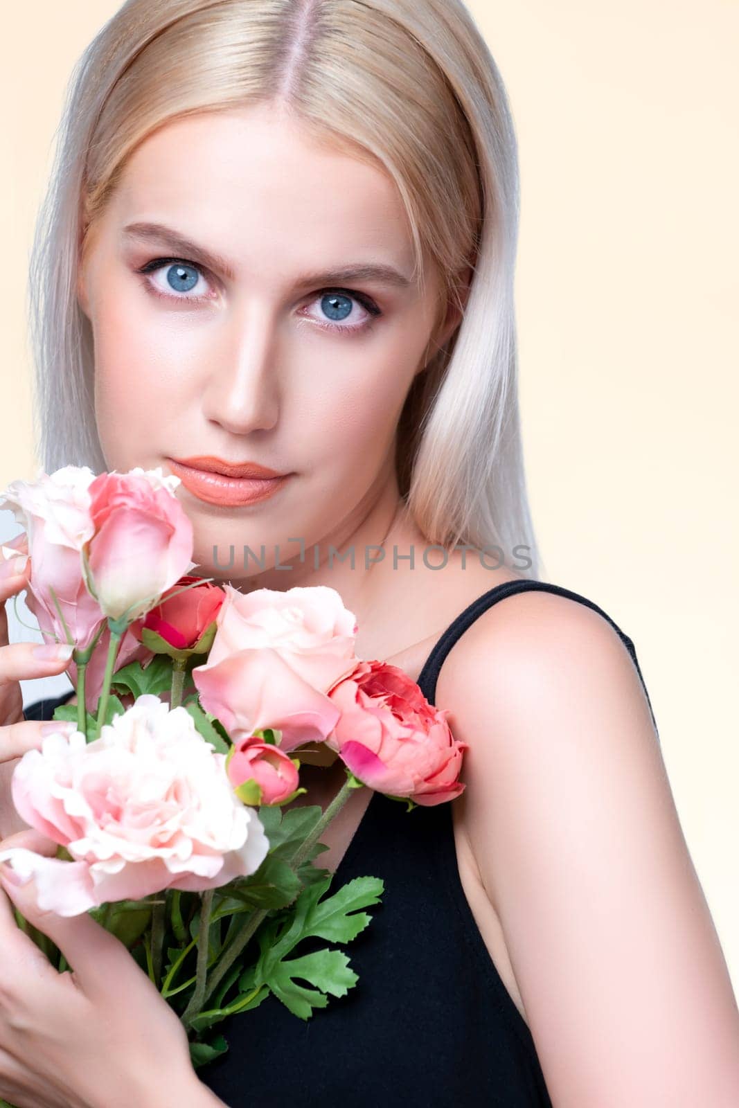 Closeup young personable woman with natural makeup and healthy soft skin holding rose for beauty care advertising in isolated background. Beautiful pretty model girl with flower concept.