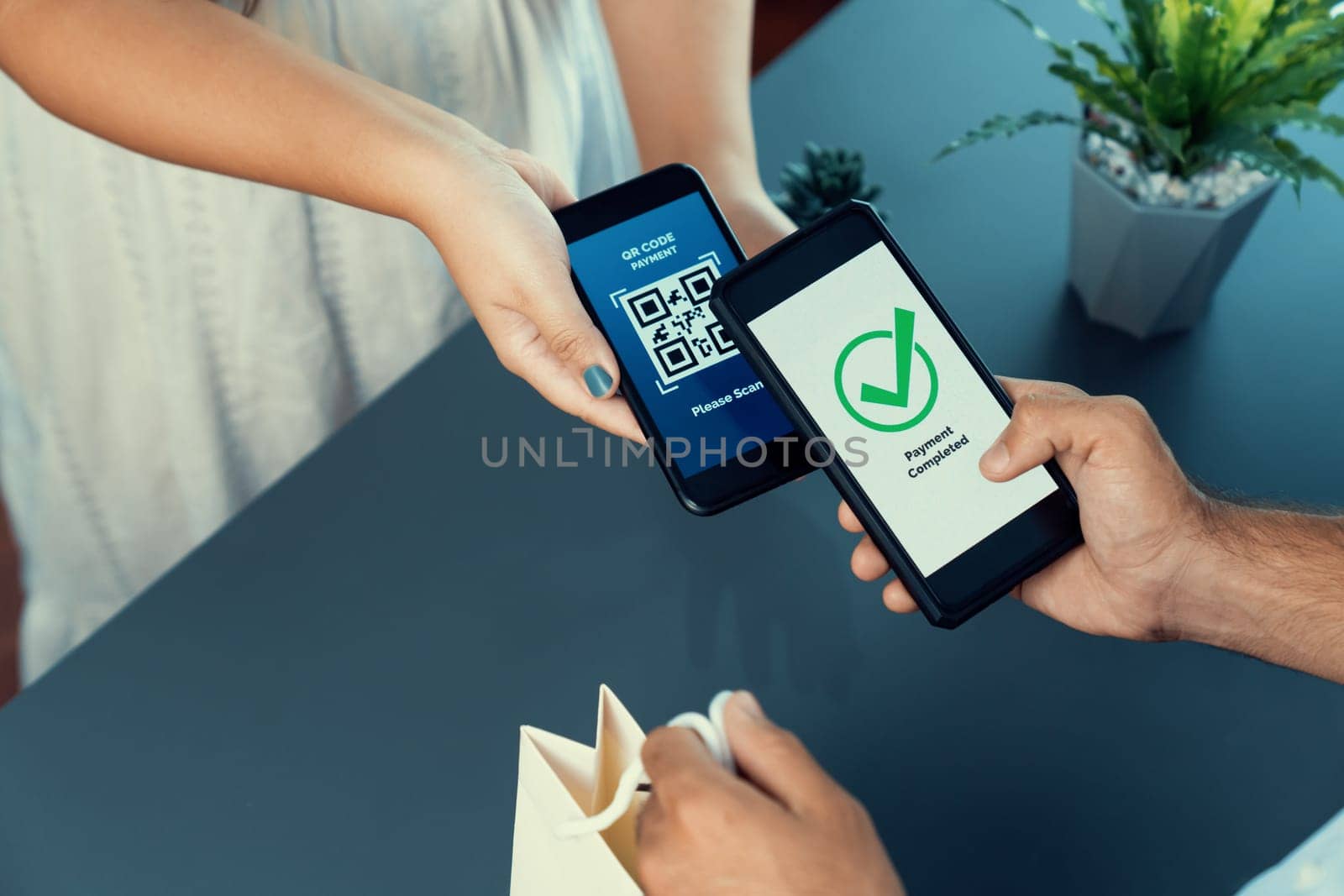 QR code displayed on screen for cashless payment scanning. Closeup hands hold smartphone to transfer money by electronic transaction from mobile app. Bar code technology for fast payment. Fervent