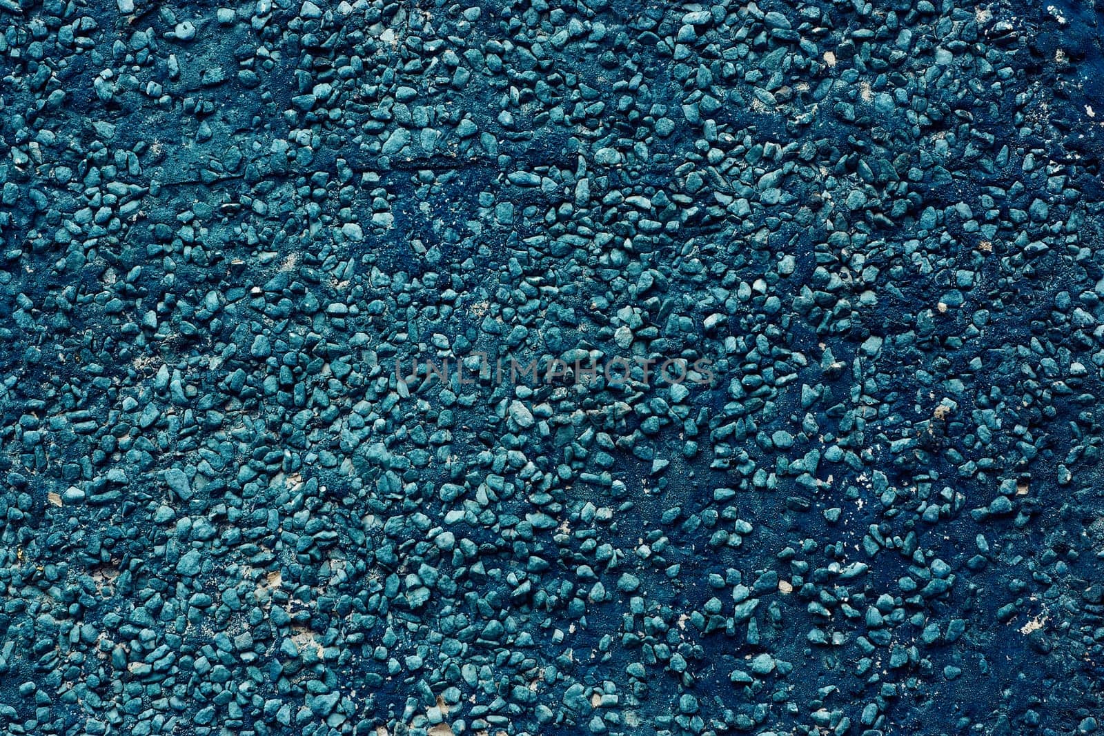 Texture of dark blue pebbles, abstract background of small stones