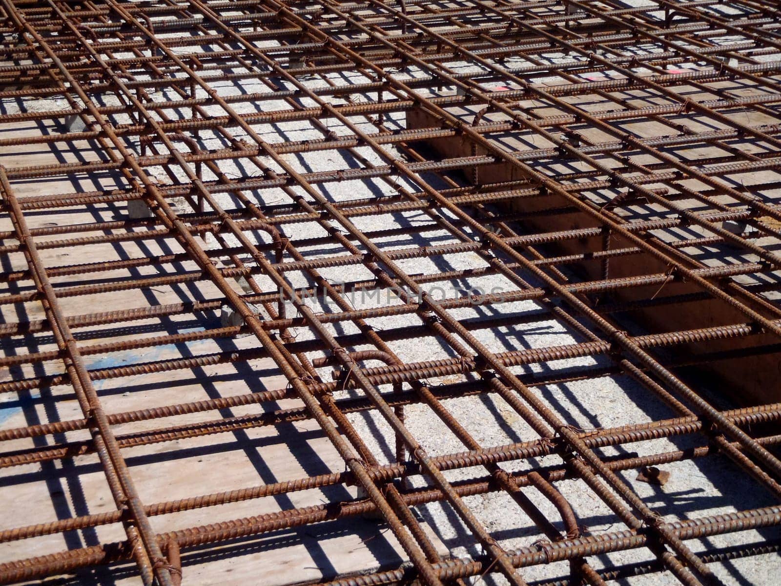 Interconnected with iron rods, and known as rebar, to reinforce the force soon to be poured concrete.