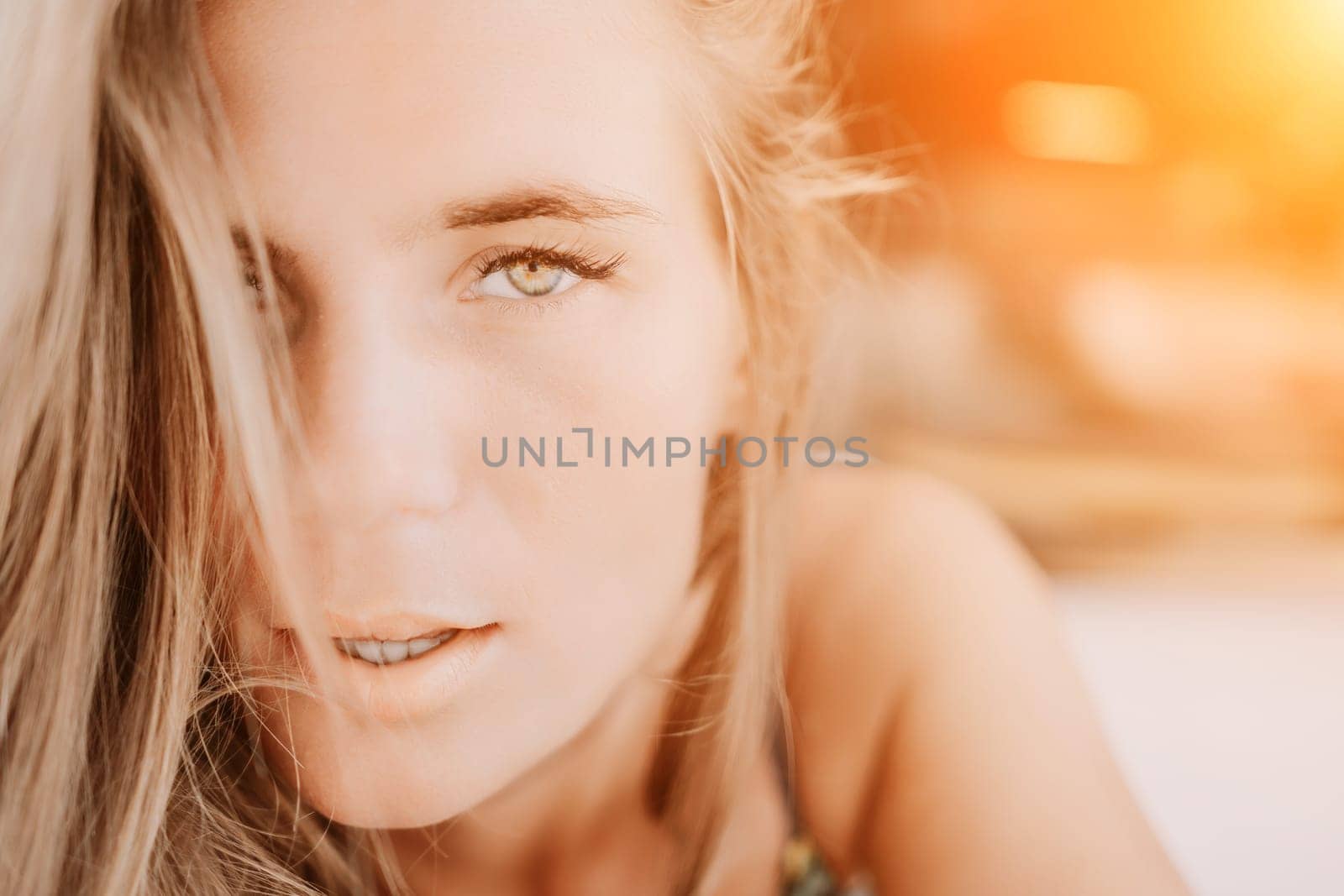 Happy woman portrait in cafe. Boho chic fashion style. Outdoor photo of young happy woman with long hair, sunny weather outdoors sitting in modern cafe